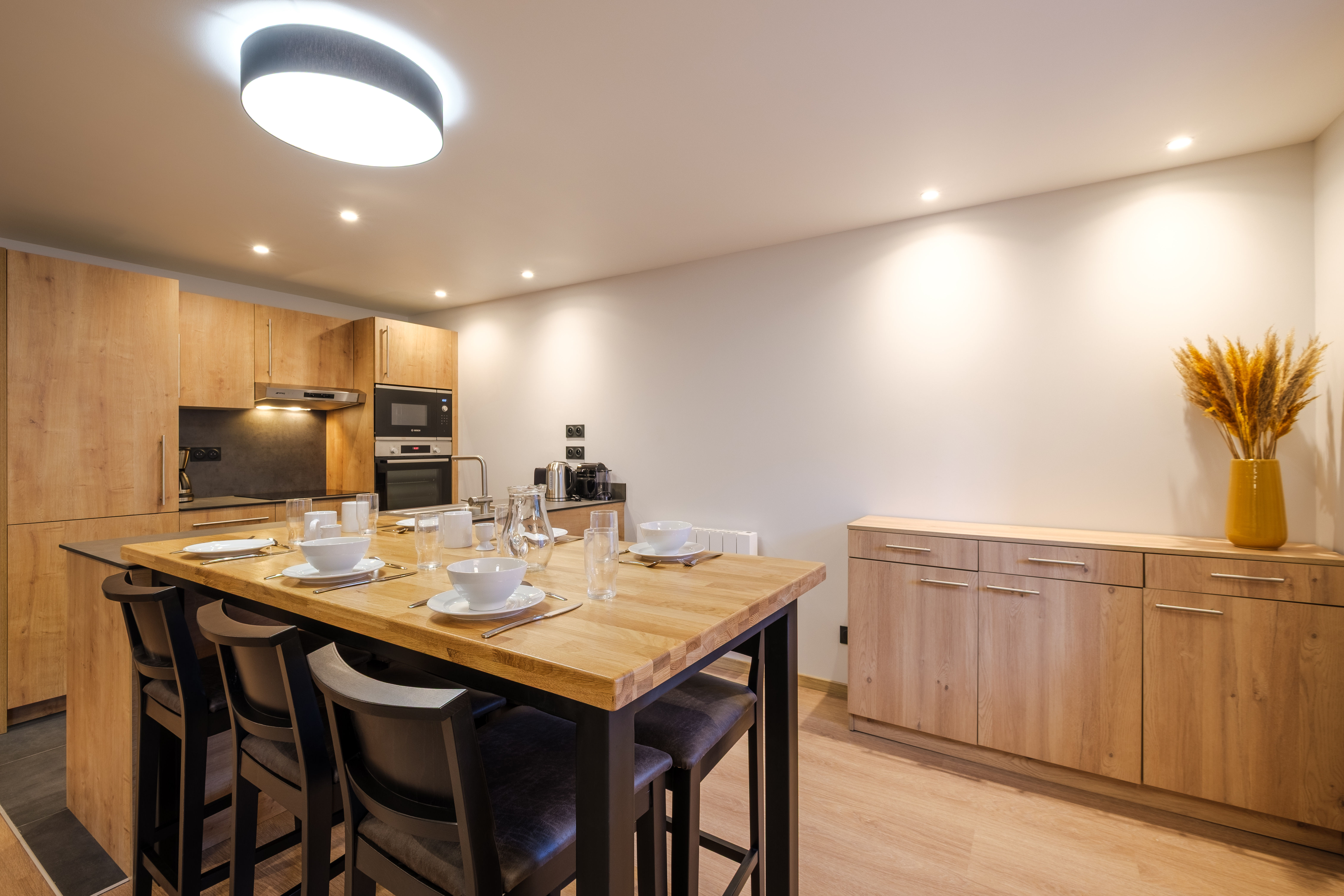 image The modern kitchen is fully equipped with sleek cabinetry and appliances, making it easy to prepare meals for the whole group.