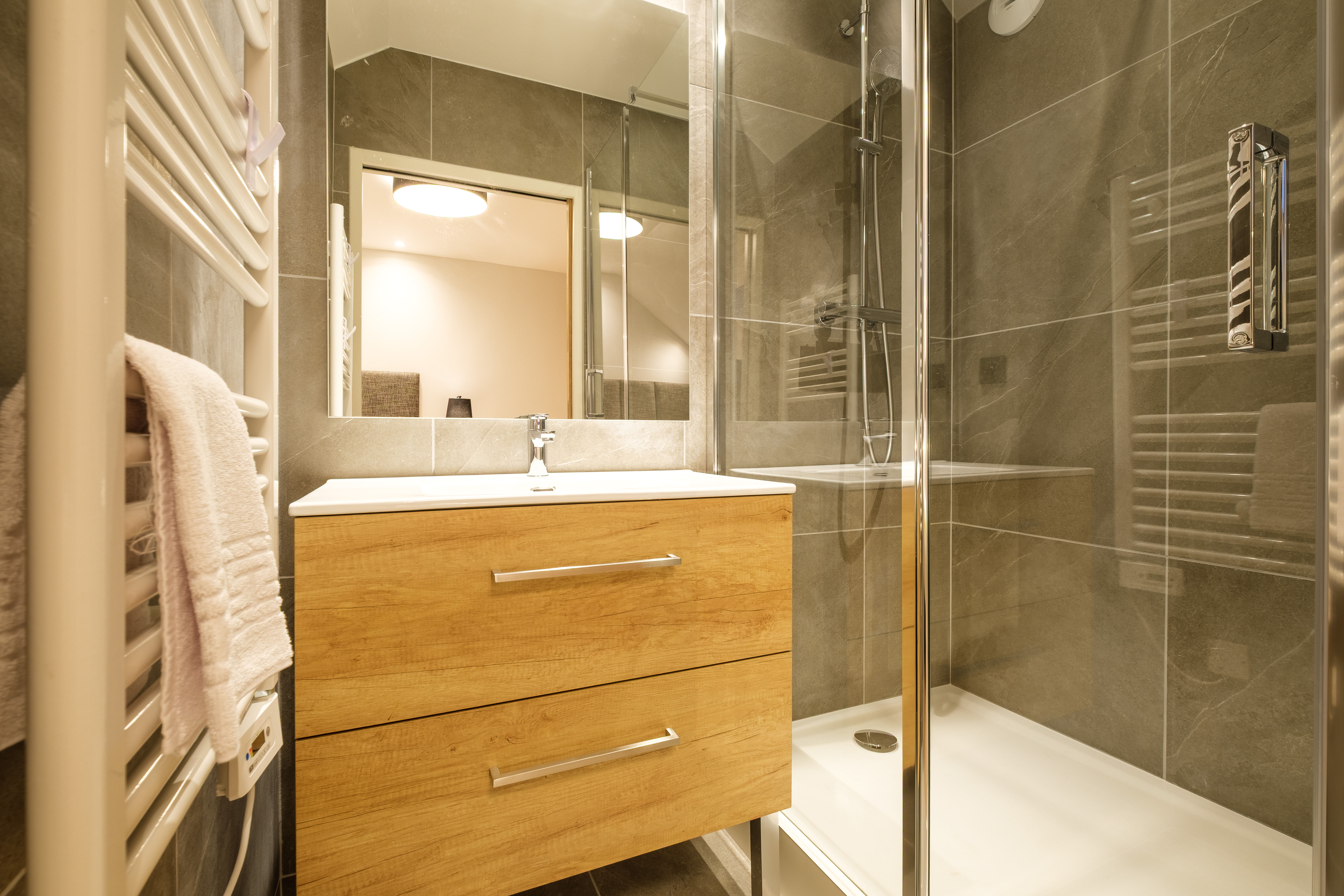 image The modern bathroom features a sleek shower and contemporary finishes for everyday comfort.