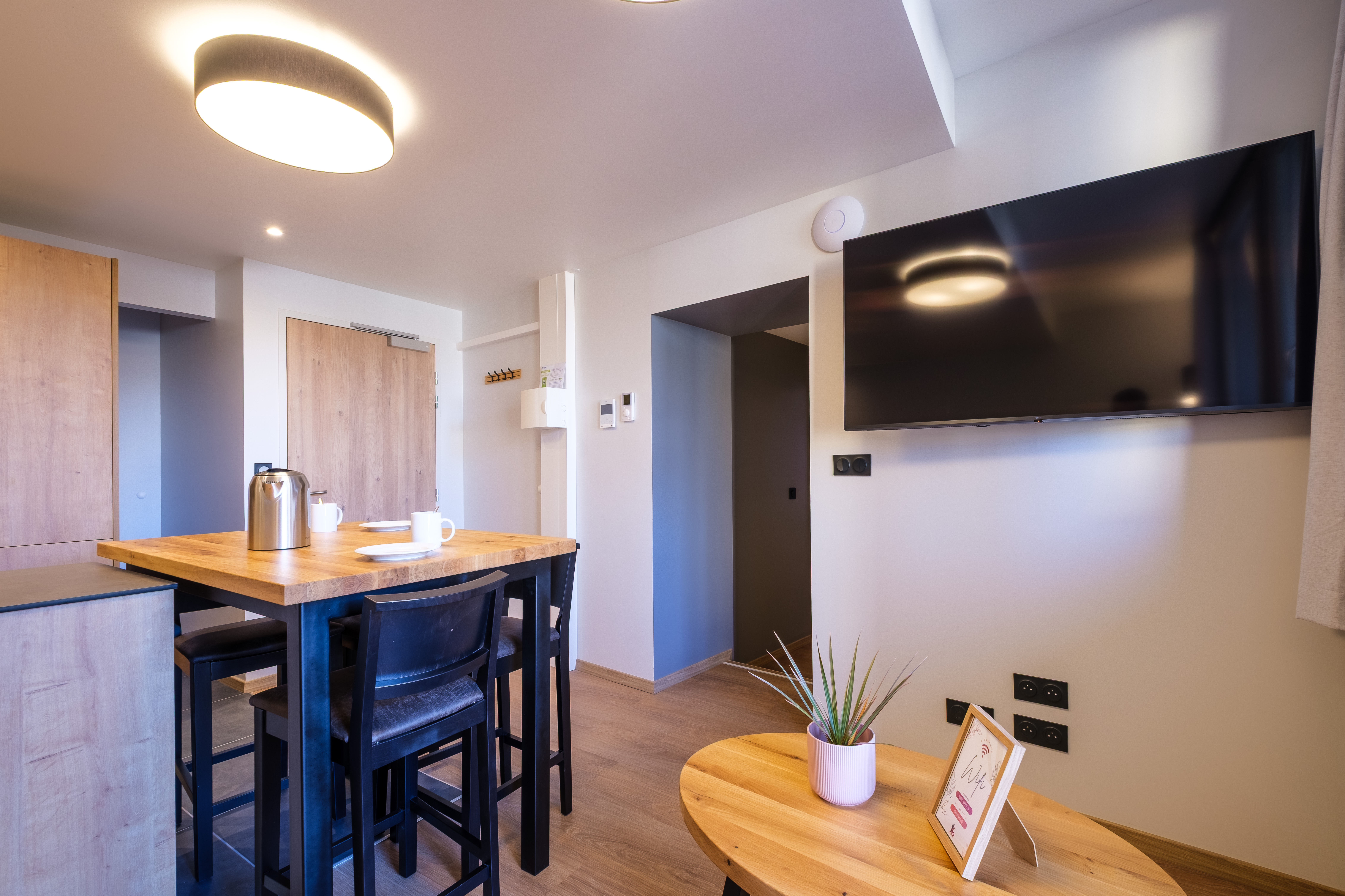 image The open living space blends a comfortable seating area with the dining table, offering a welcoming layout for everyday living.