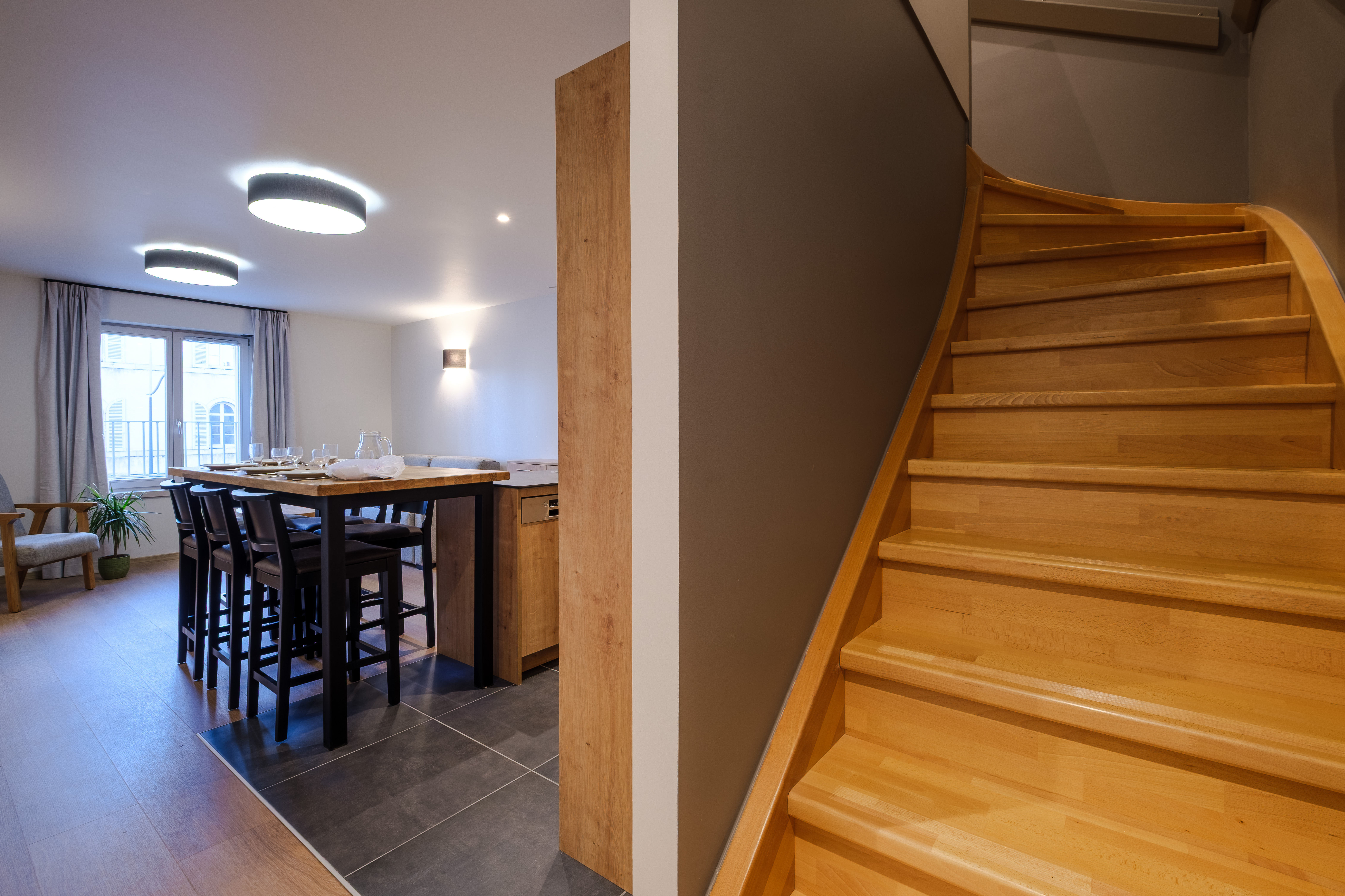 image A stylish staircase connects the levels of the duplex, adding character and a sense of space to the apartment.