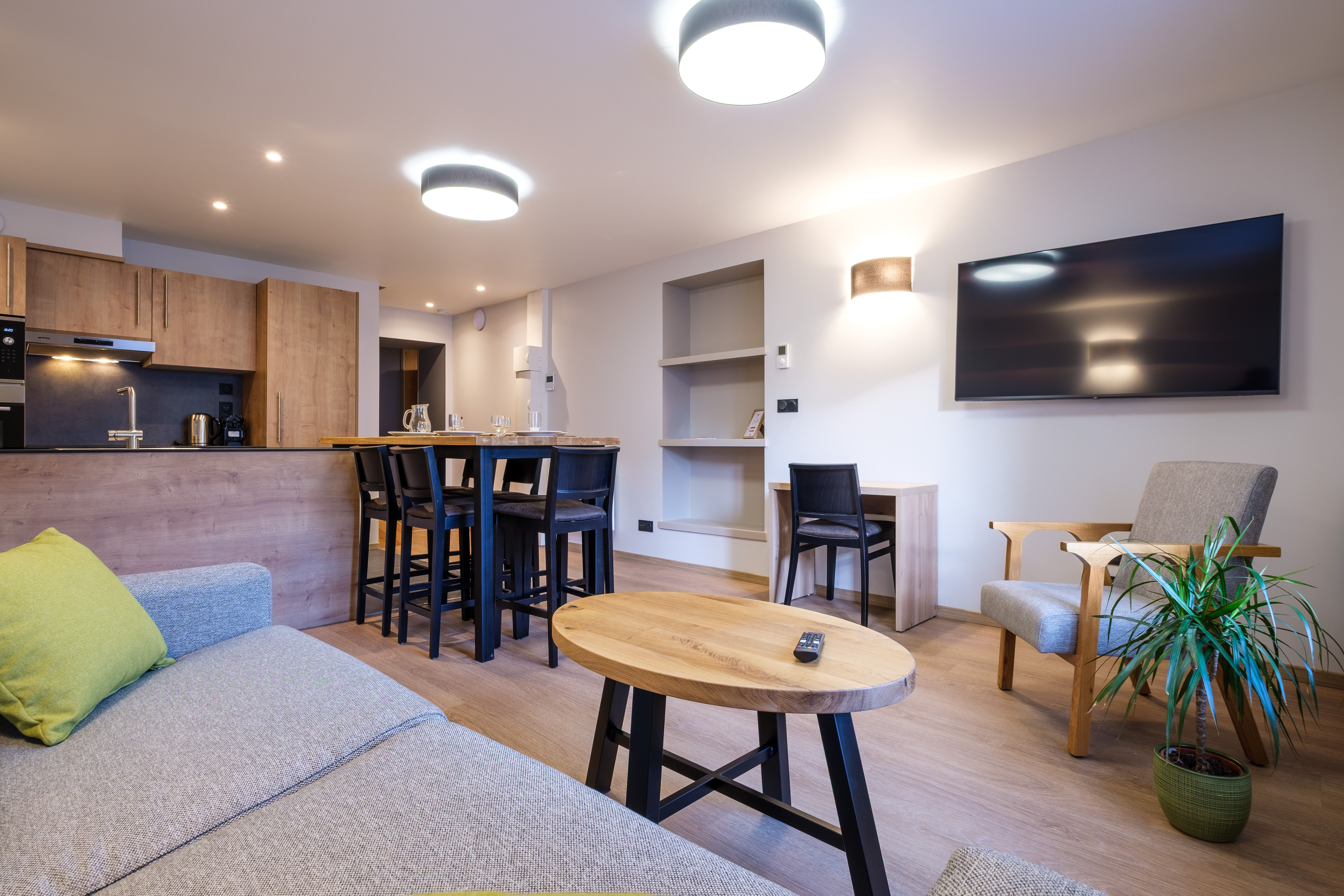 image The bright living area features a comfortable sofa bed, dining table, and TV, creating a welcoming space to relax together.