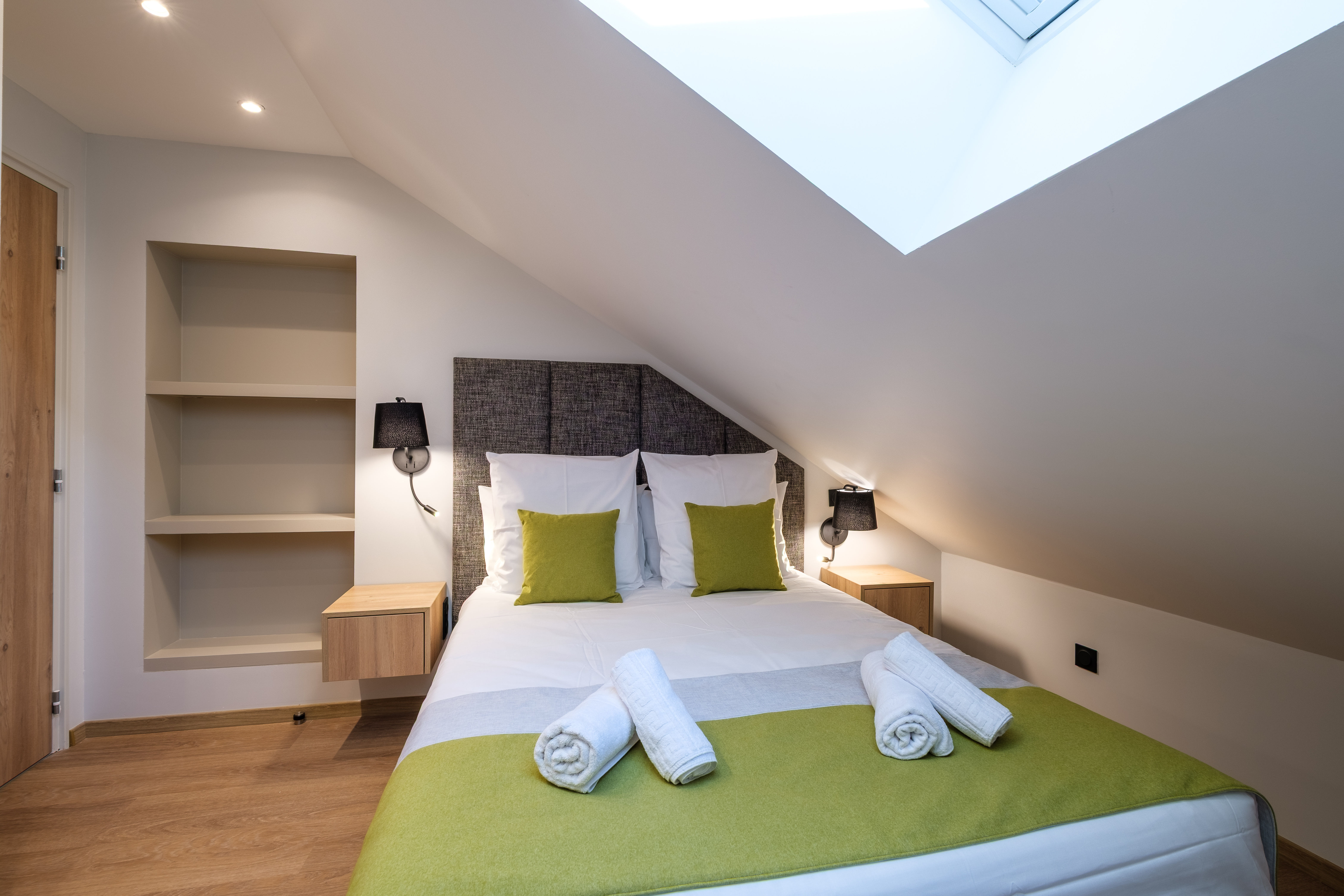 image One of the cosy bedrooms offers a calm retreat with comfortable bedding and modern decor.