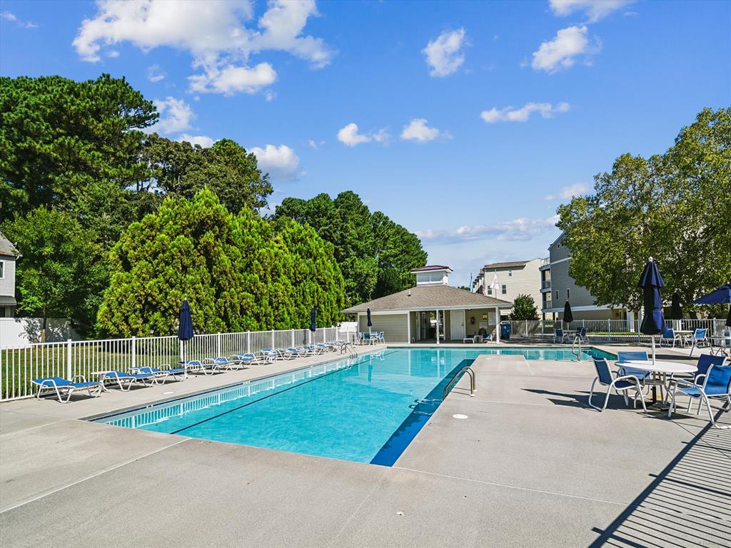 image The outdoor pool area offers space to lounge, unwind, and enjoy sunny days surrounded by trees.