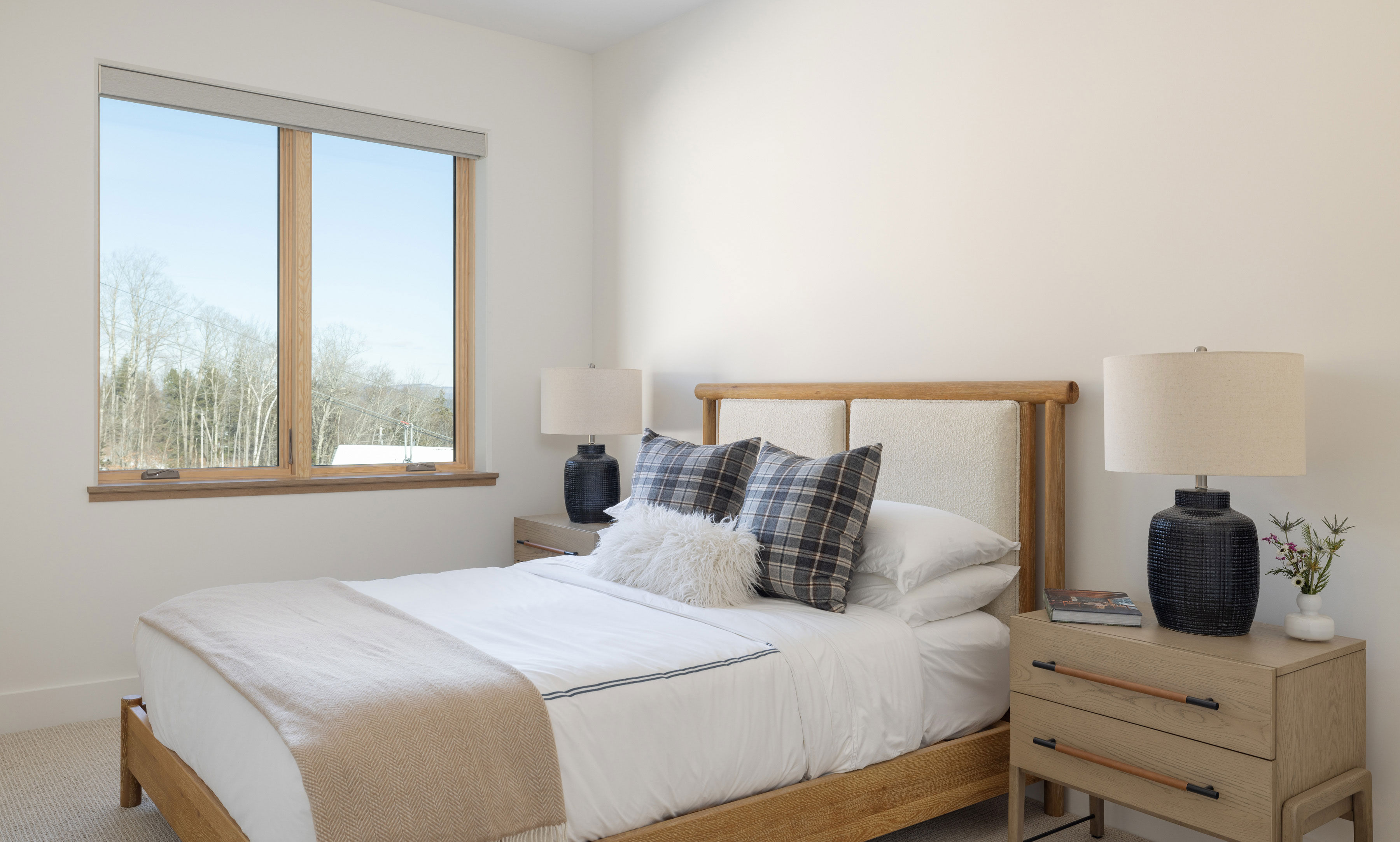 image One of the inviting bedrooms features plush bedding and natural light, creating a peaceful retreat for guests after a full day on the mountain.