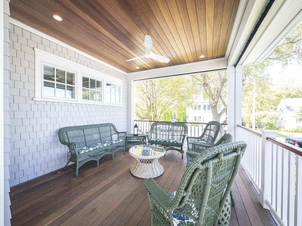 image This charming porch area offers a serene space to unwind, complete with comfortable seating and charming views.