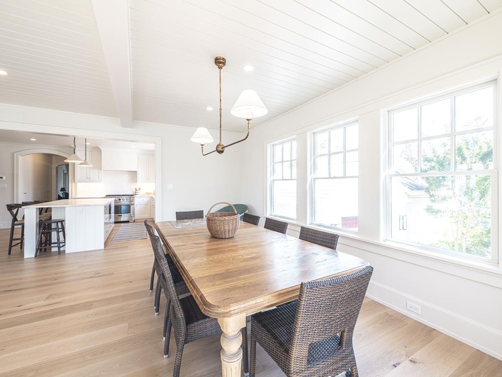 image Cozy dining space accentuated by large windows and rustic touches, creating a warm atmosphere for shared meals.