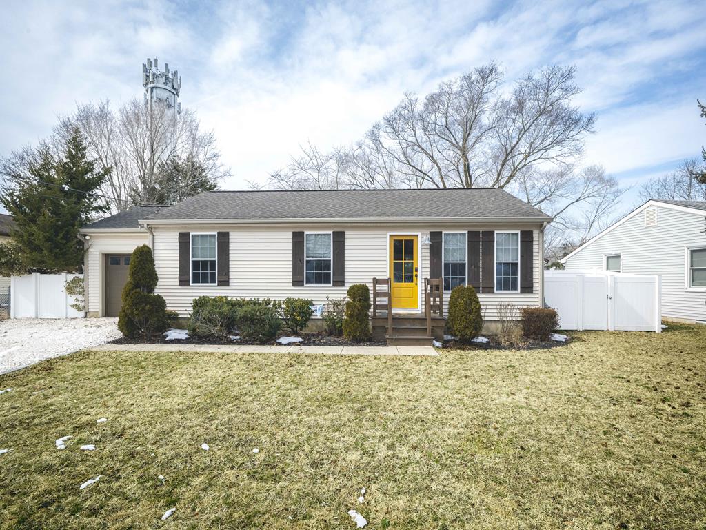 image Welcome to your charming coastal retreat, featuring a bright yellow front door that invites you into this delightful 4-bedroom vacation home.
