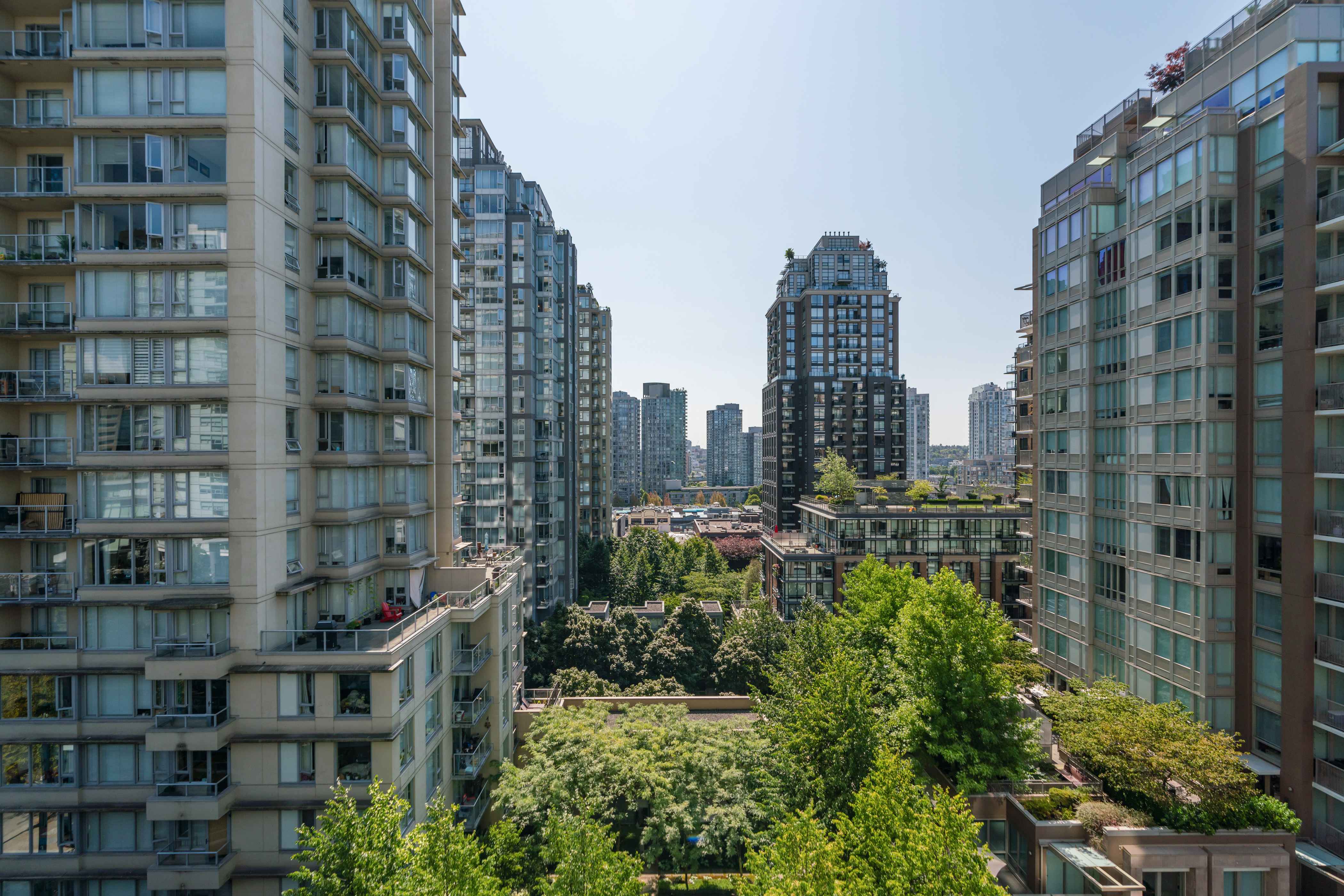 image Cityscape view showcasing surrounding Yaletown buildings and treetops from the suite.