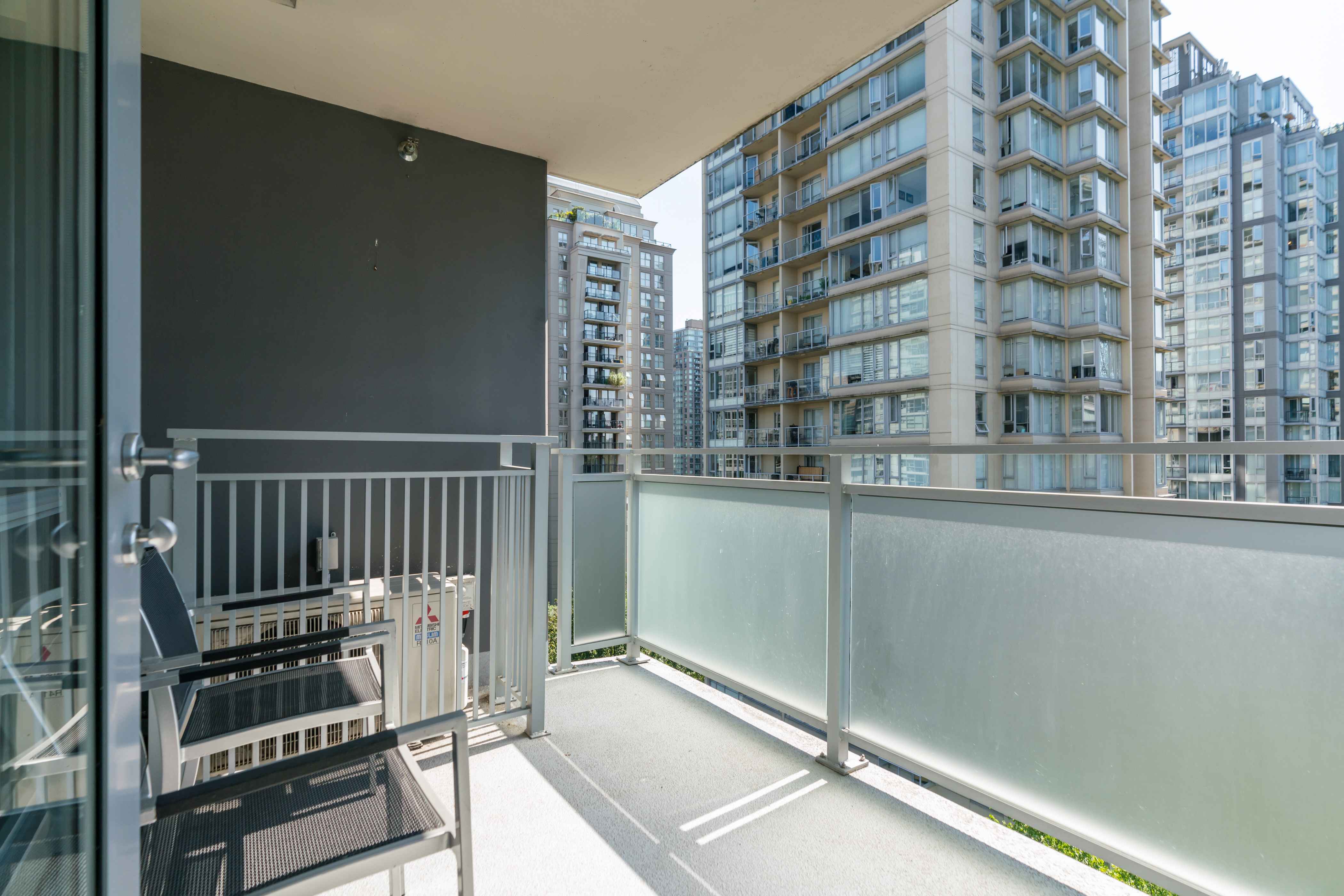 image Private balcony with seating and city views, offering a relaxing outdoor space in the heart of Yaletown.