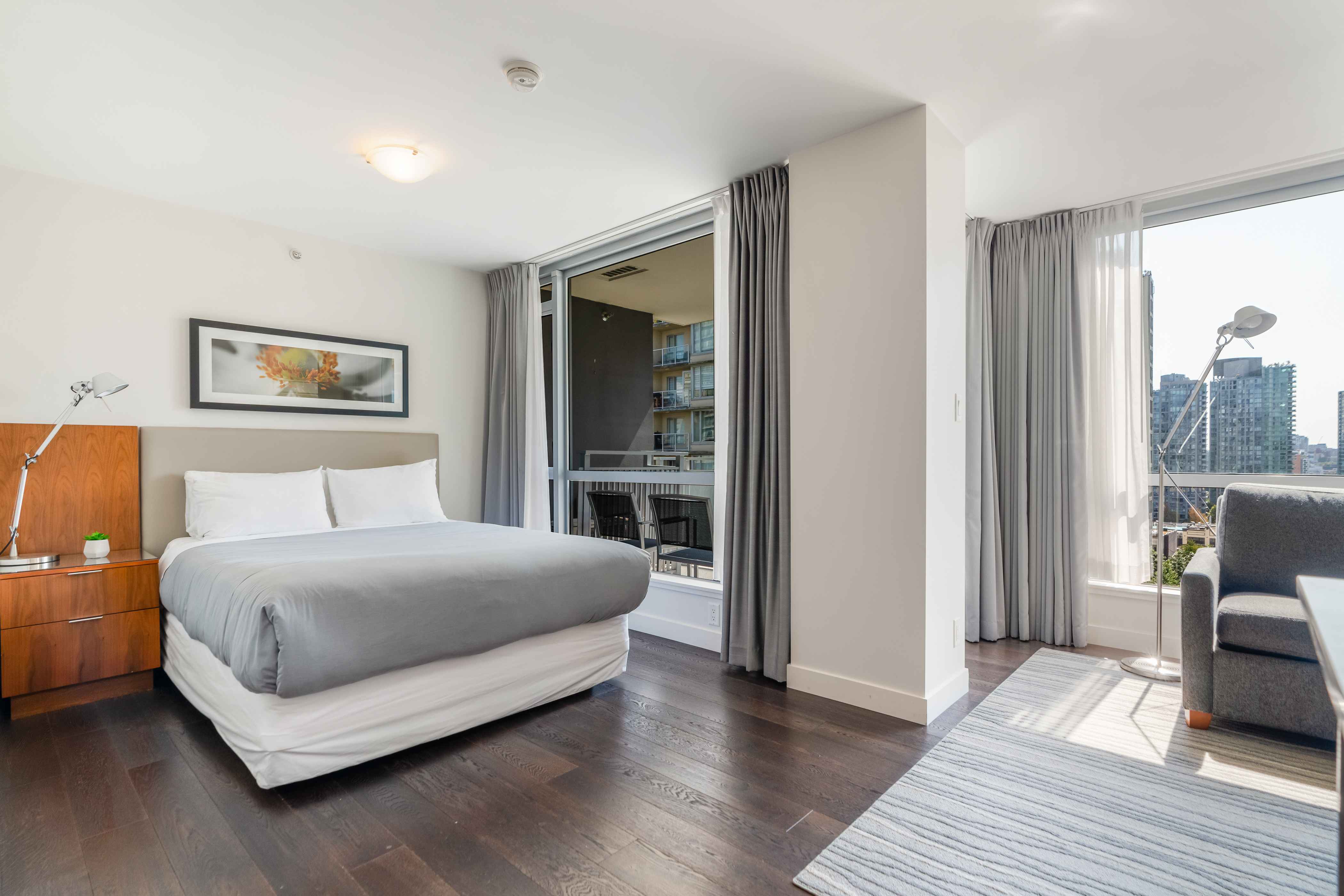 image Studio sleeping area with a comfortable bed, natural light, and direct access to the private balcony.