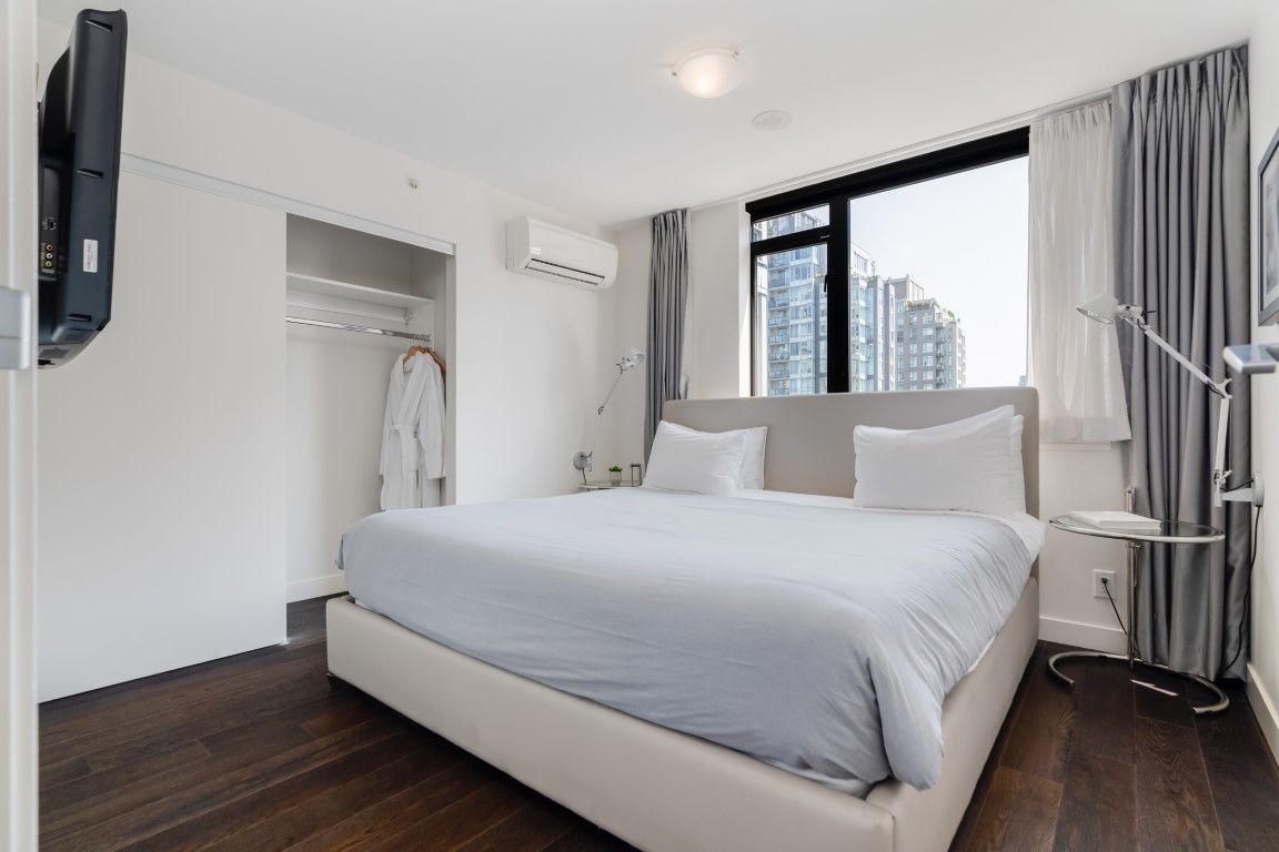 image The cozy bedroom, designed for relaxation, is enhanced by large windows that flood the space with natural light and showcase stunning outdoor views.