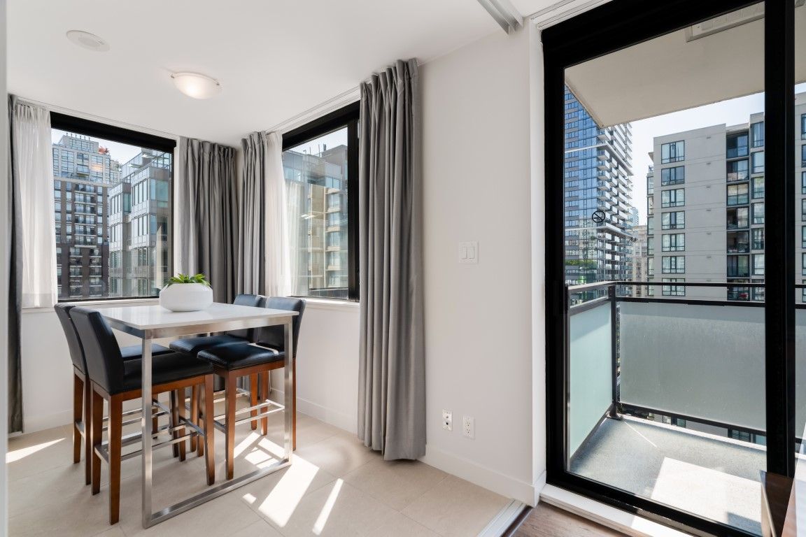 image Bright and airy, this nook features large windows and modern furnishings, offering picturesque urban views of Vancouver's skyline.