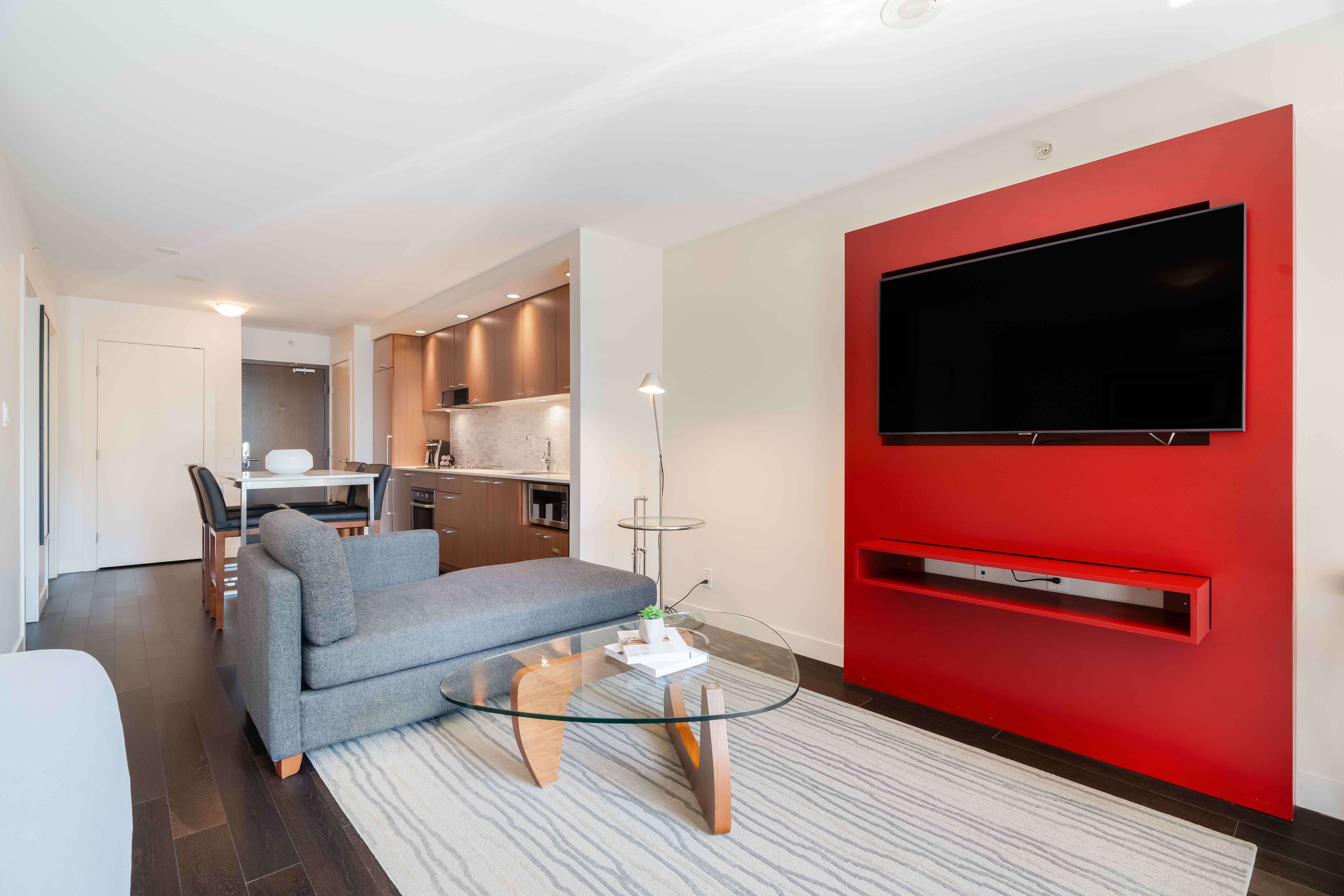 image Contemporary living area with a sofa bed, stylish décor, and a wall-mounted TV for relaxing evenings.