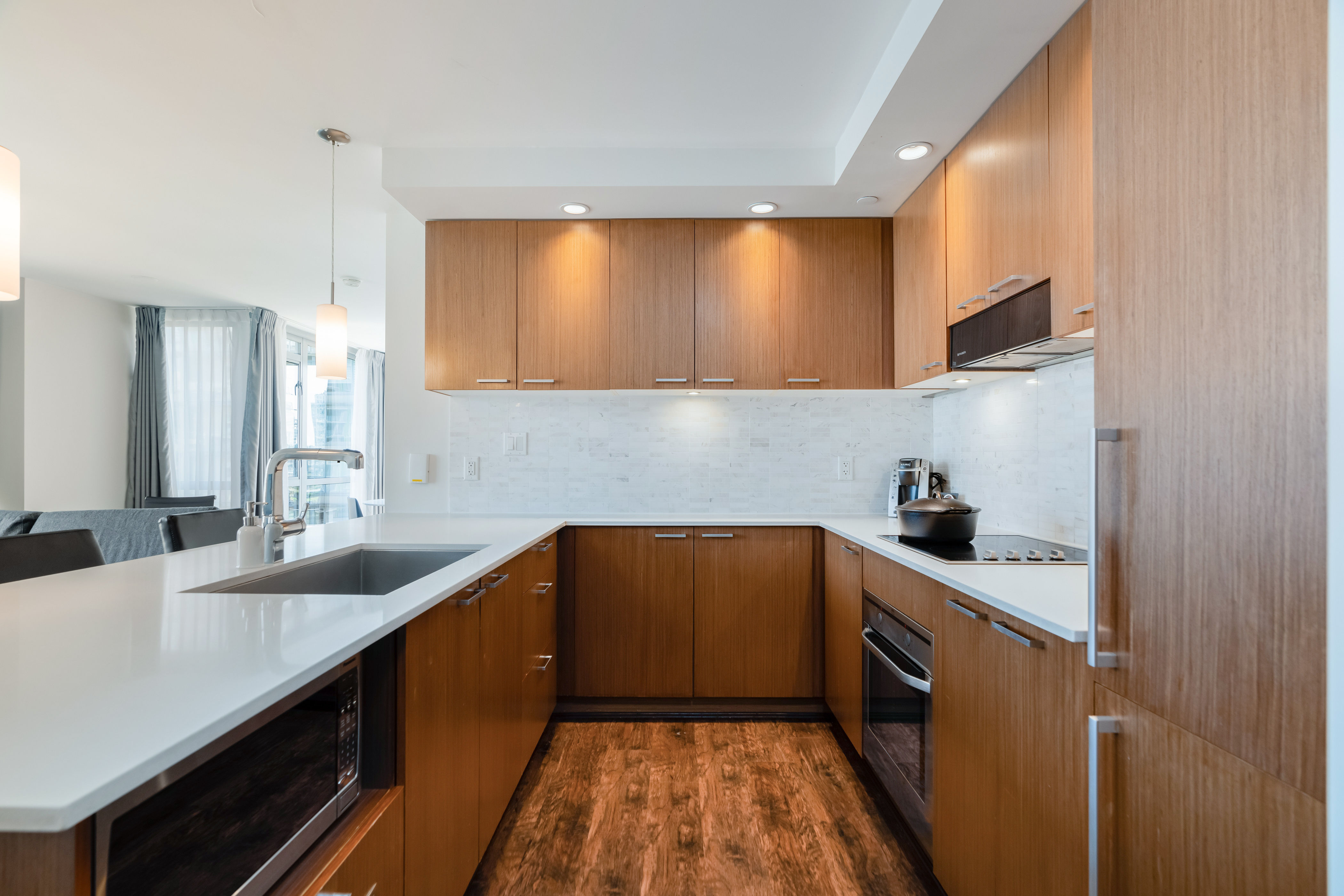 image Enjoy culinary adventures in the well-appointed kitchen, which boasts elegant cabinetry, high-end appliances, and a functional layout.