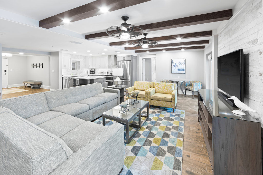 image Spacious living room with plush seating and an open layout, perfect for gathering with family and friends.