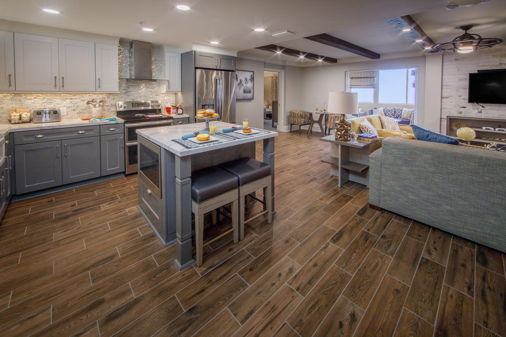 image Spacious primary bedroom featuring a king-size bed, crisp linens, and a calm coastal atmosphere.