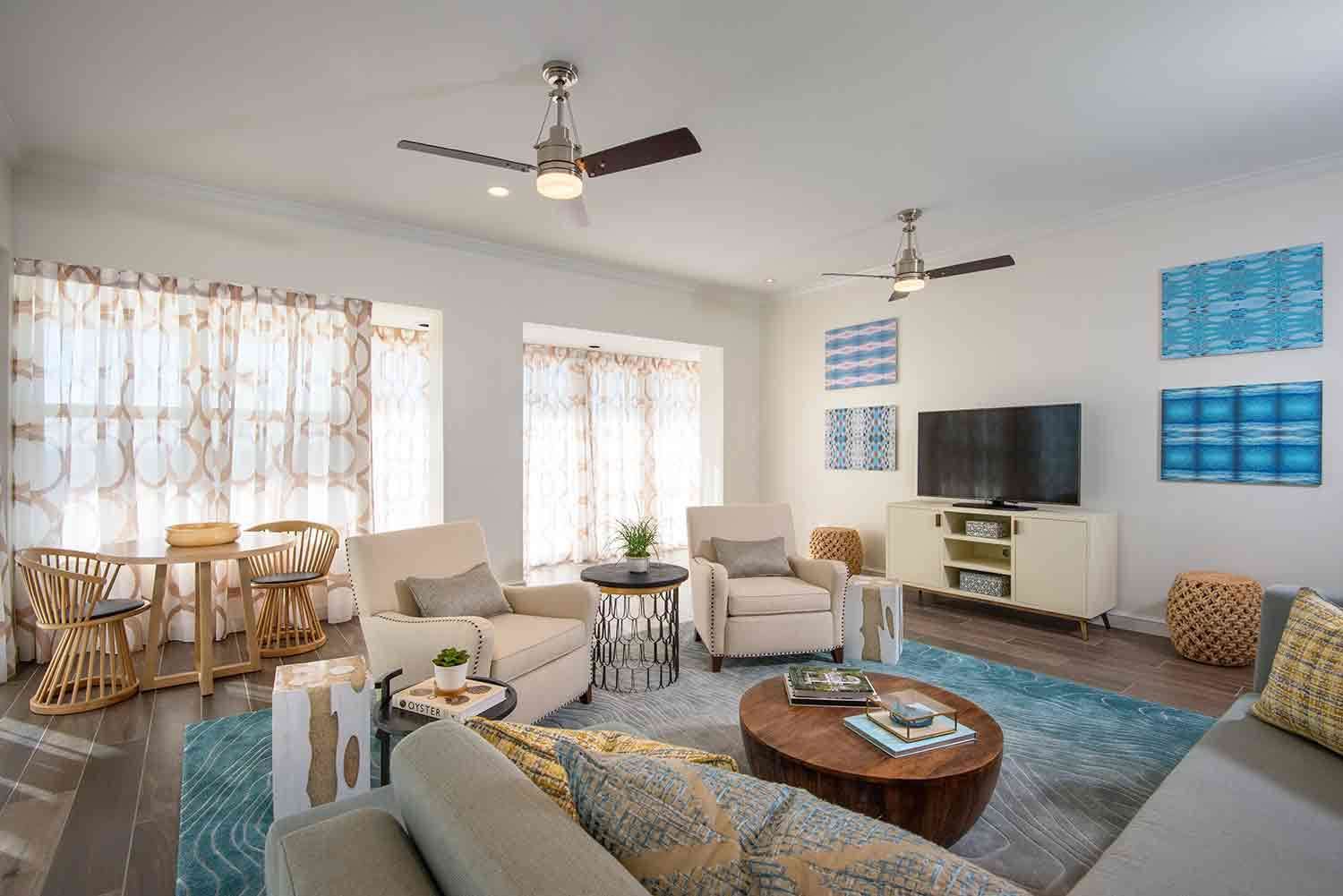 image Stylish and airy, this living area boasts a chic coastal design, making it perfect for entertaining or unwinding. Large windows invite the beach vibes inside, enhancing every moment spent here.