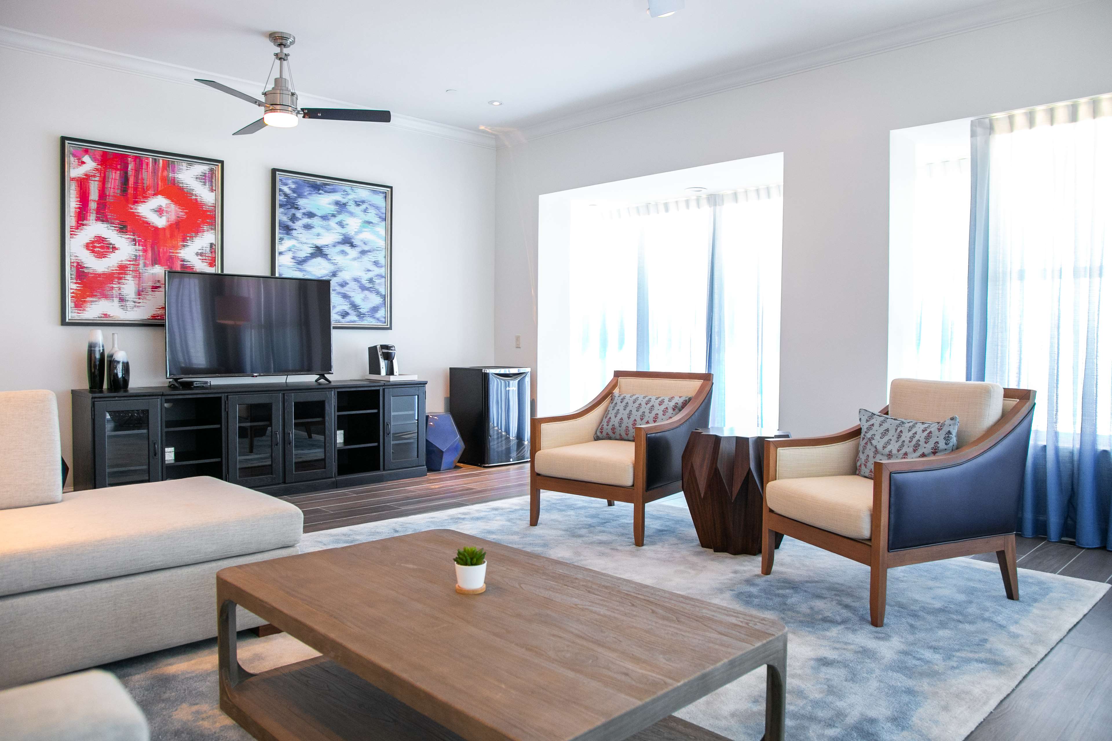 image An oasis of contemporary comfort, the living area invites relaxation with its ocean-inspired décor and abundant natural light pouring through expansive windows.