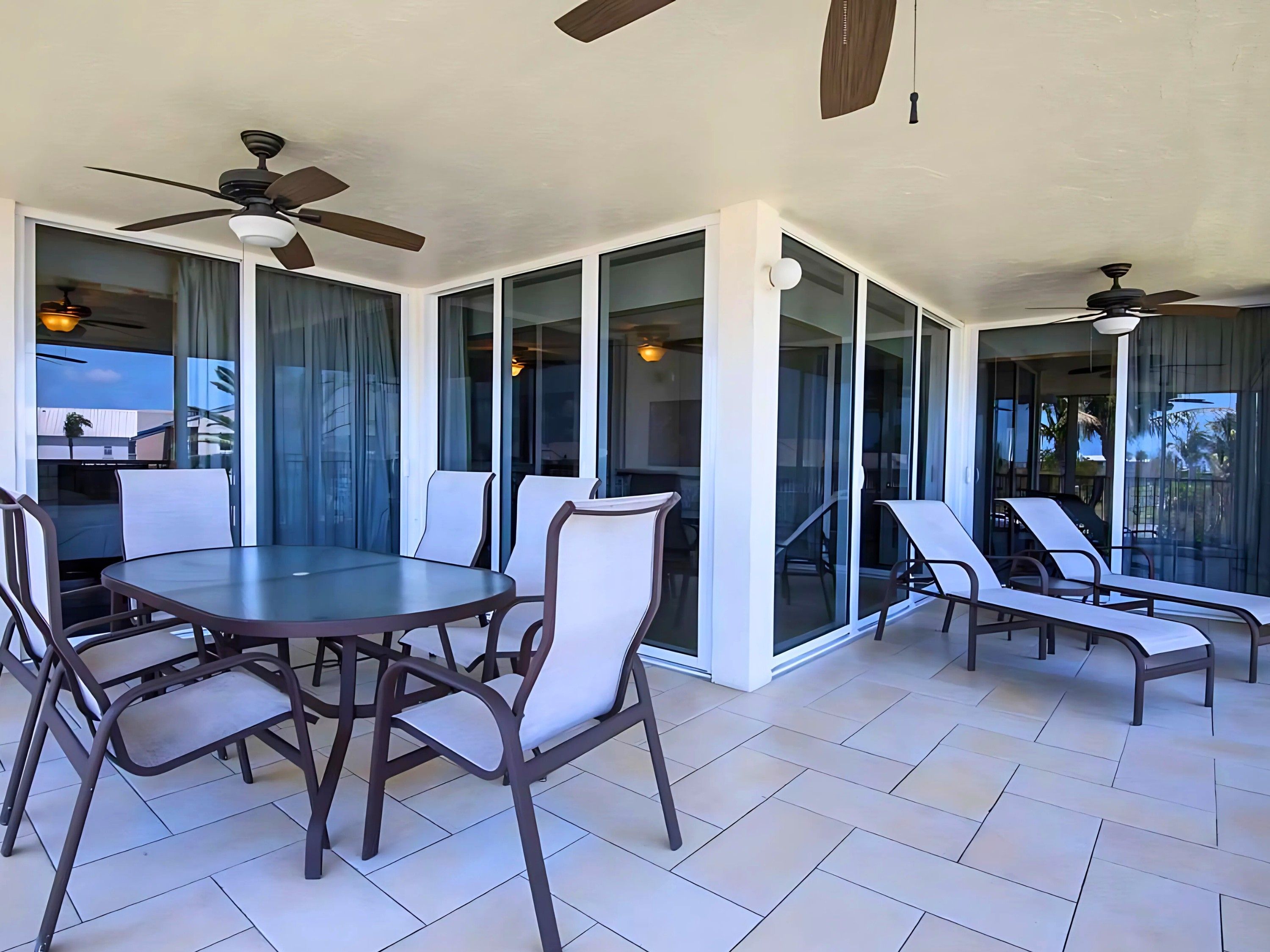 image Dine al fresco on the spacious screened porch, where the beauty of the outdoors complements every meal in this coastal retreat.
