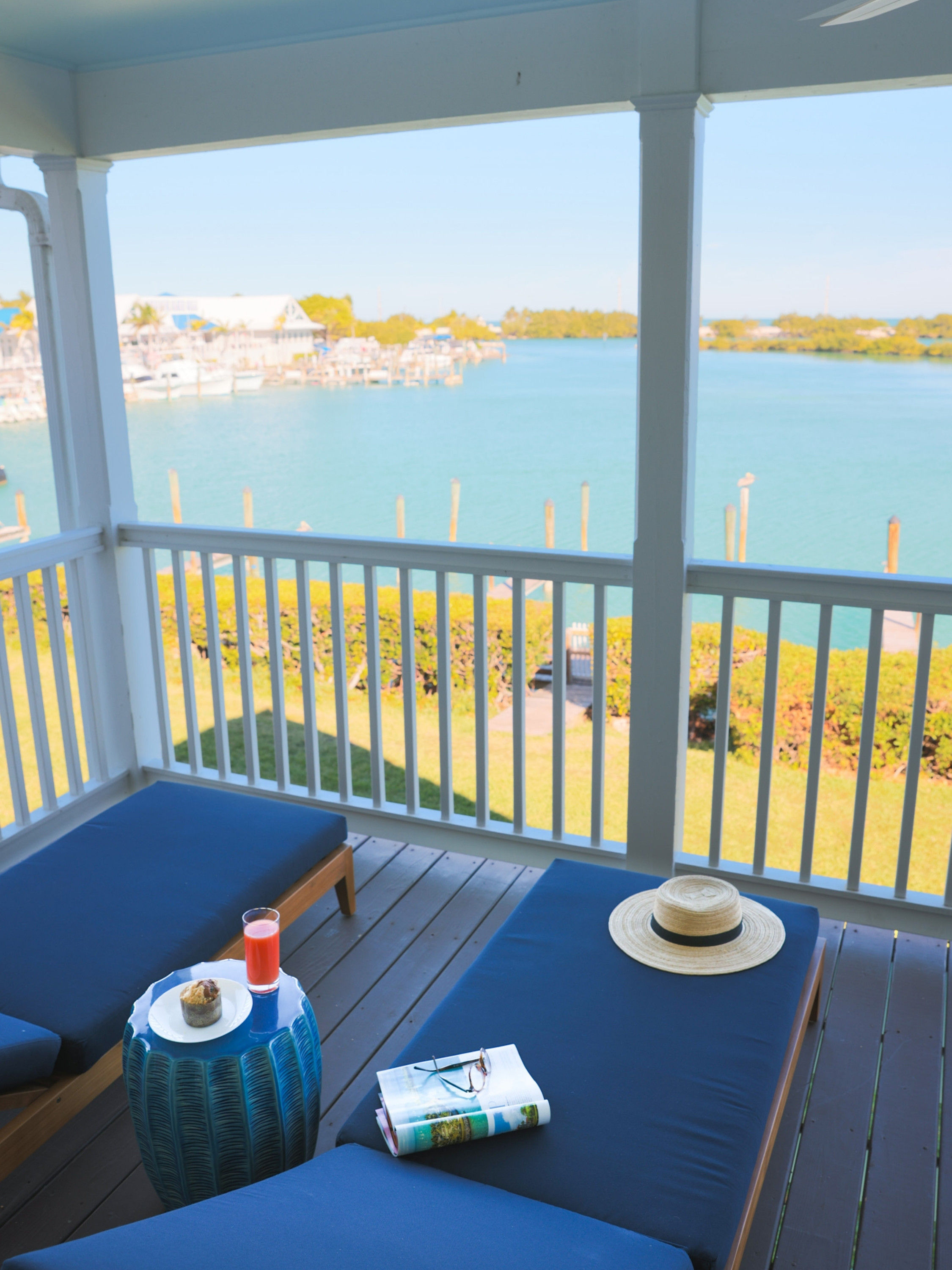 image Unwind on the breezy balcony with a refreshing drink in hand, as you soak in panoramic views of the serene waters and charming docks below.