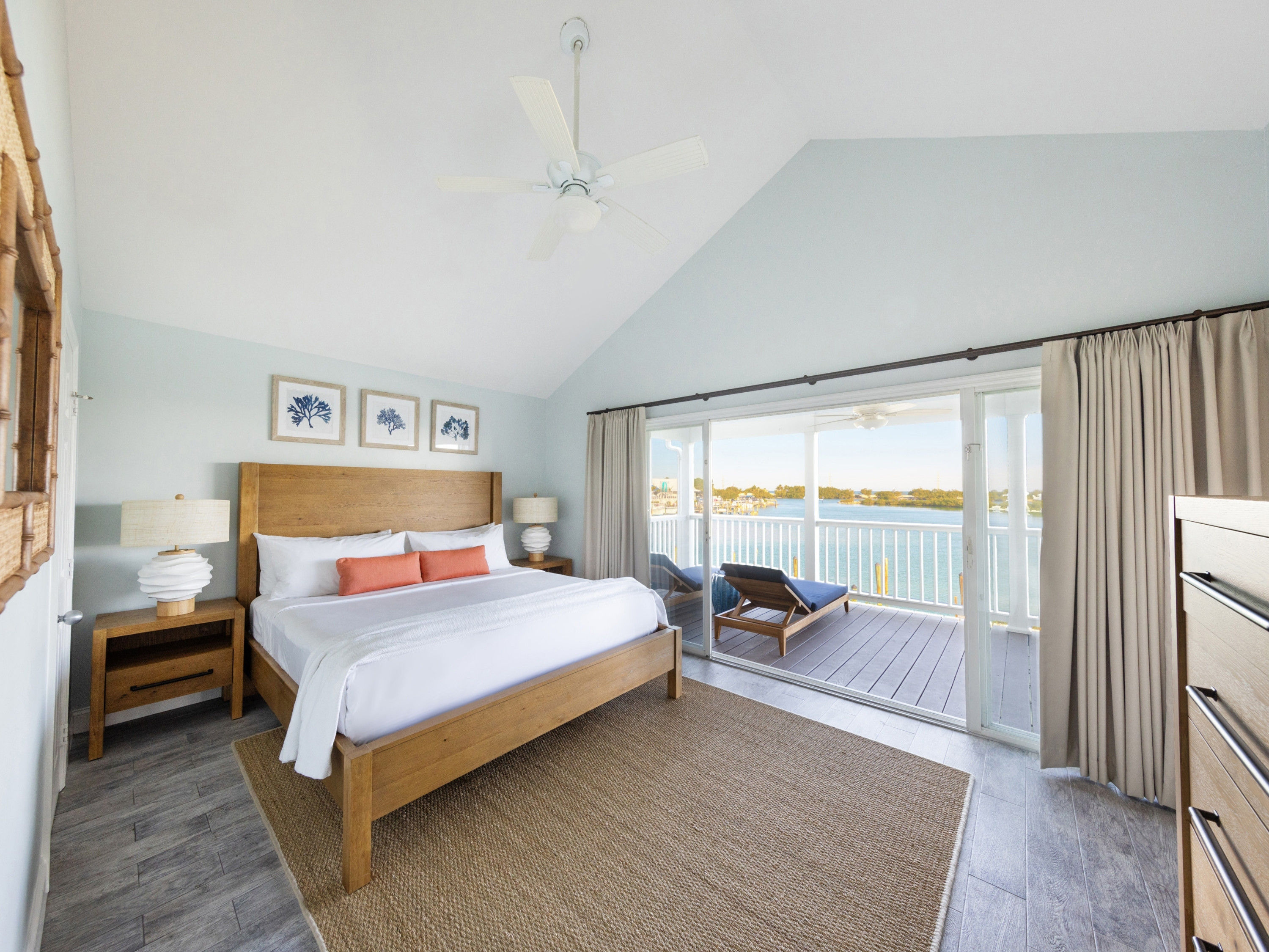 image Awake to breathtaking views in this sunlit master bedroom, where comfort meets coastal charm—the perfect haven for relaxation.