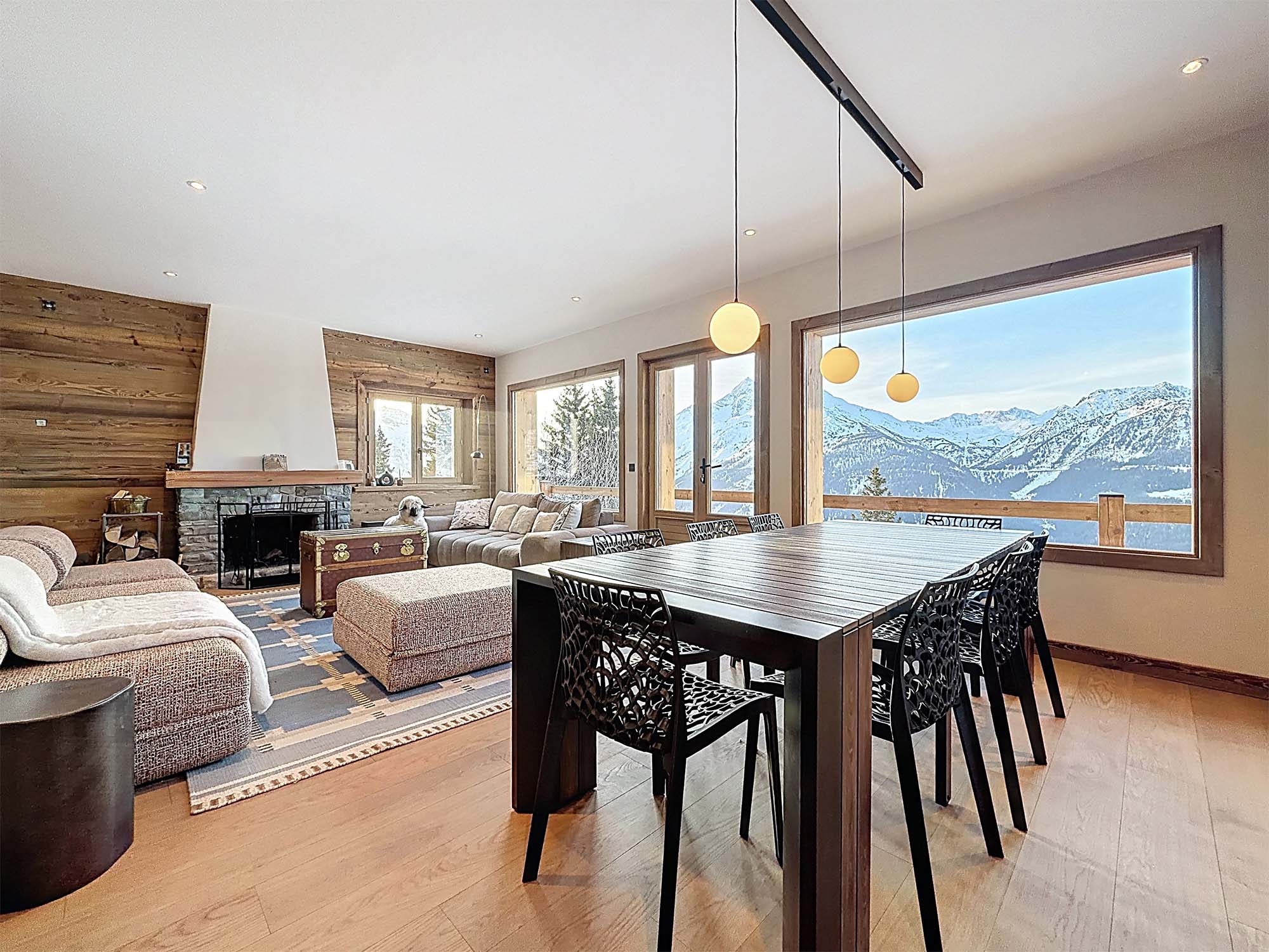 image Bright dining and living area with breathtaking mountain views, ideal for gathering and enjoying convivial moments together.
