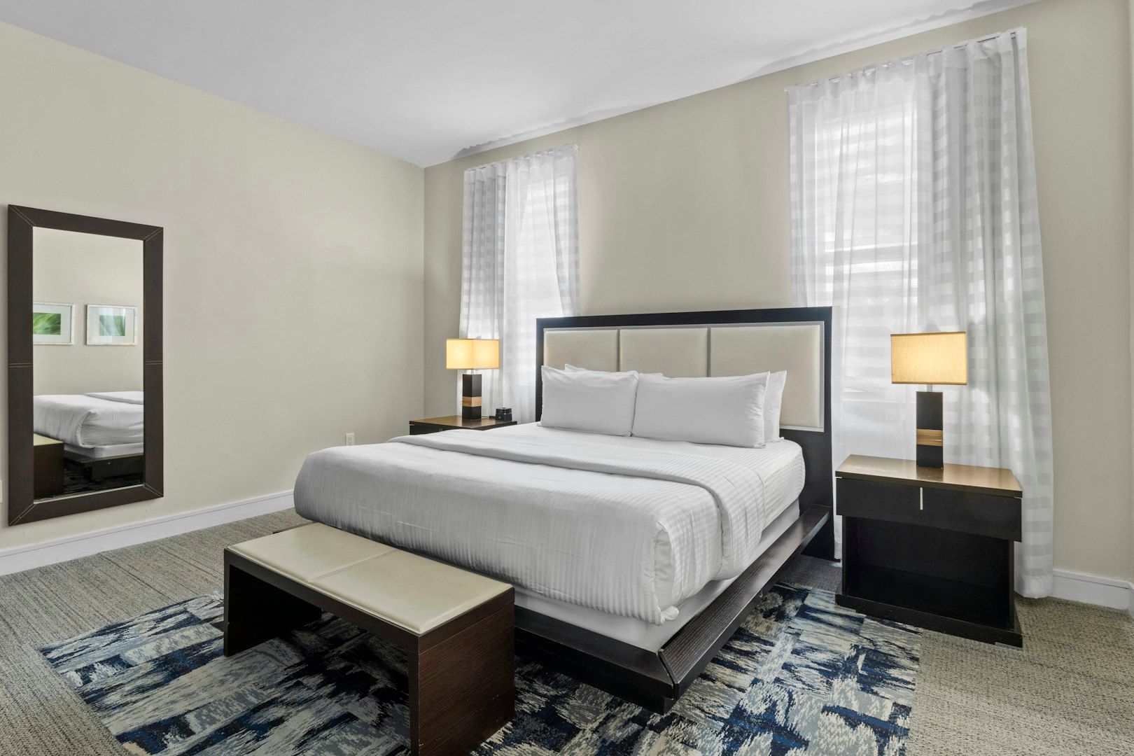 image Serene bedroom featuring a plush bed, bedside lamps, and a calm, neutral color palette.