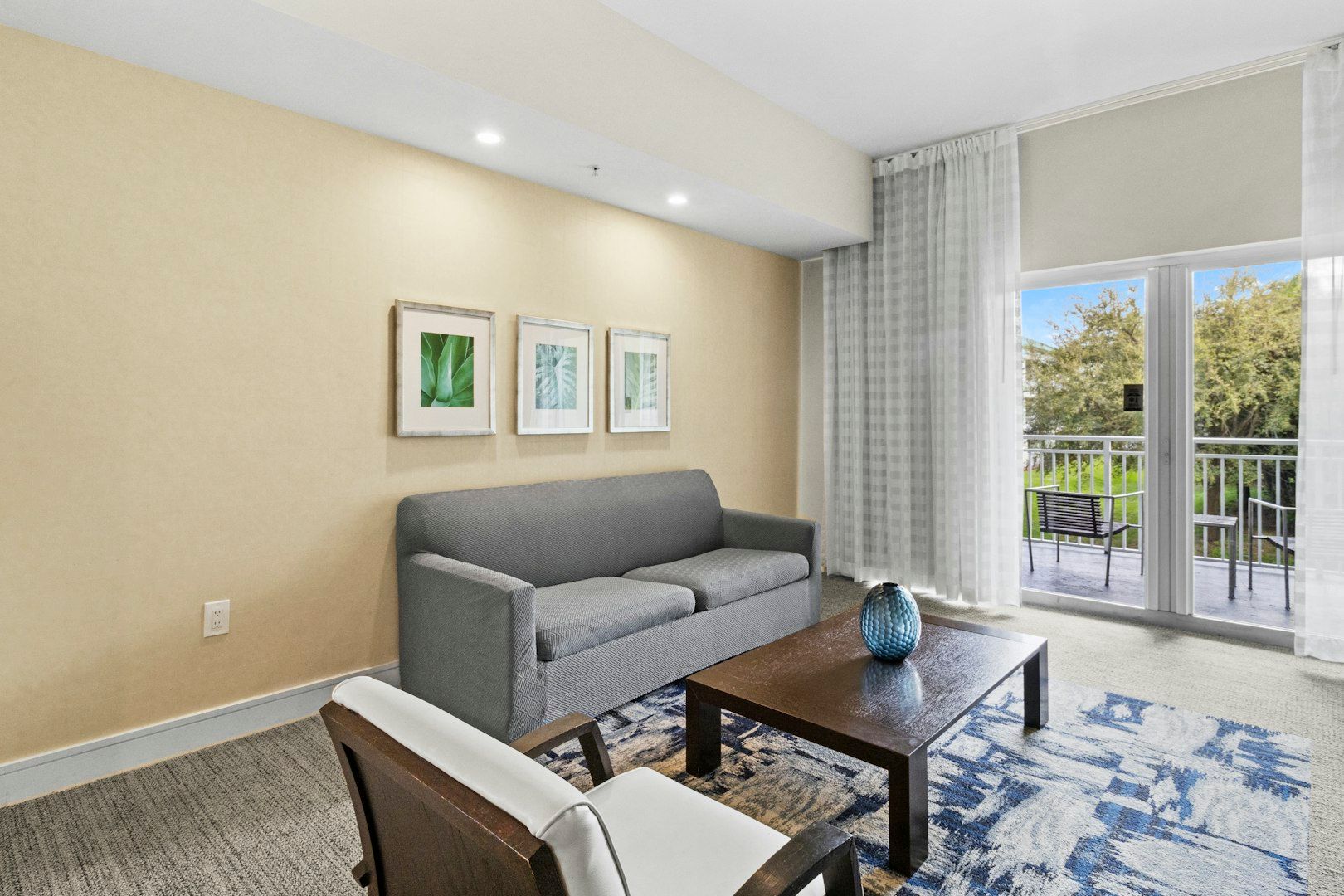 image Bright living area with a comfortable sofa, modern décor, and direct access to the private balcony.