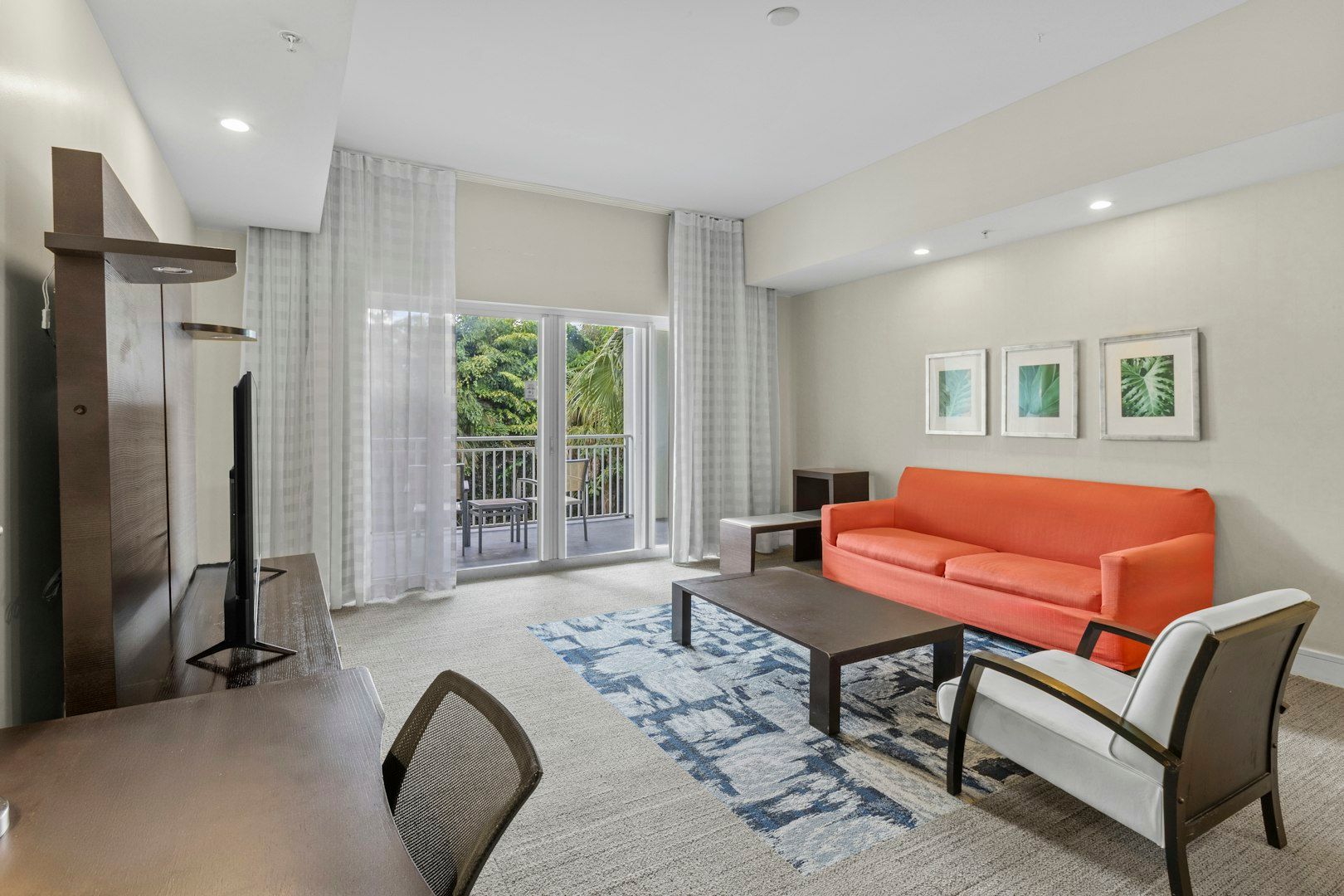 image Bright living area with a comfortable sofa, modern décor, and natural light creating a welcoming space to relax.