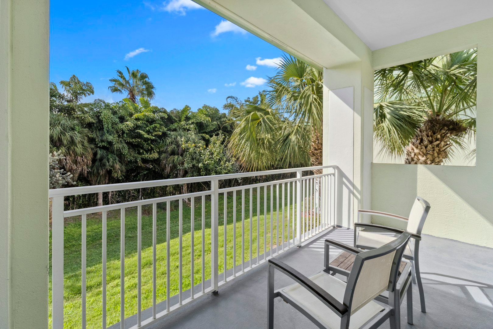 image Private balcony with seating and lush garden views, perfect for enjoying fresh air and sunshine.