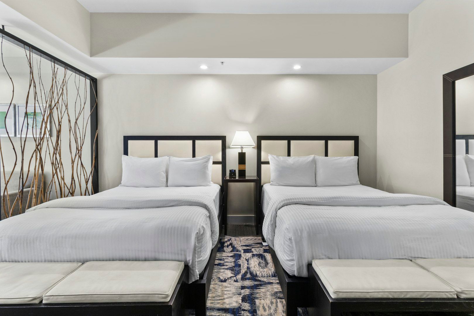 image Accessible sleeping area with two plush beds, generous spacing, and a calm, modern design.