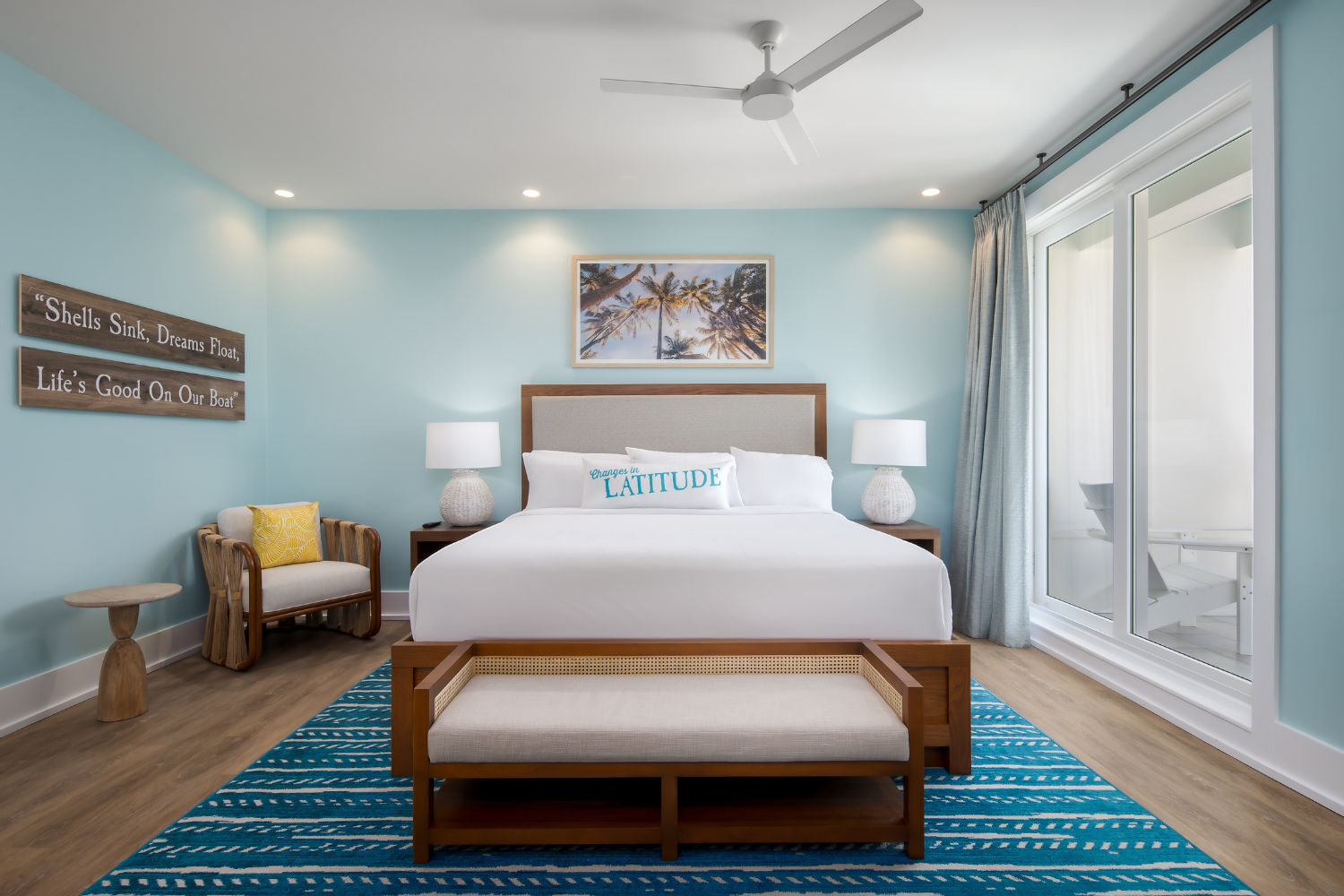 image Elegant and serene, this bedroom offers a tranquil retreat adorned with coastal accents and bright, airy colors.