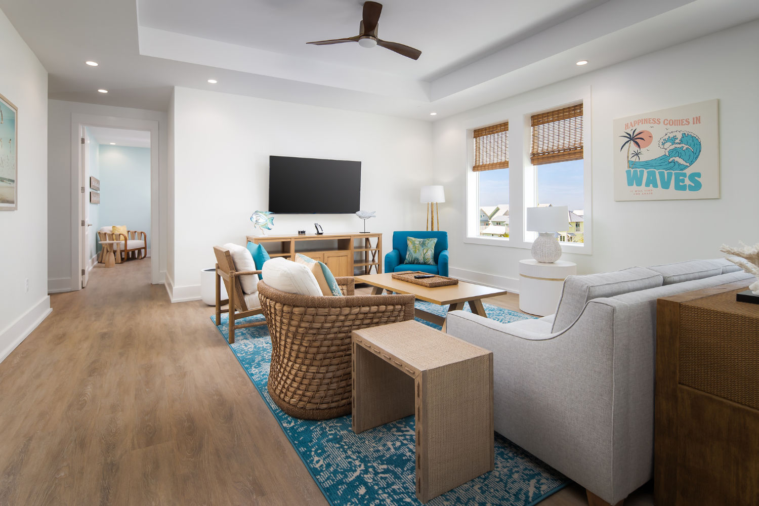 image Bathed in natural light, this stylish living area showcases tasteful furnishings and a cheerful atmosphere with oceanic artwork.