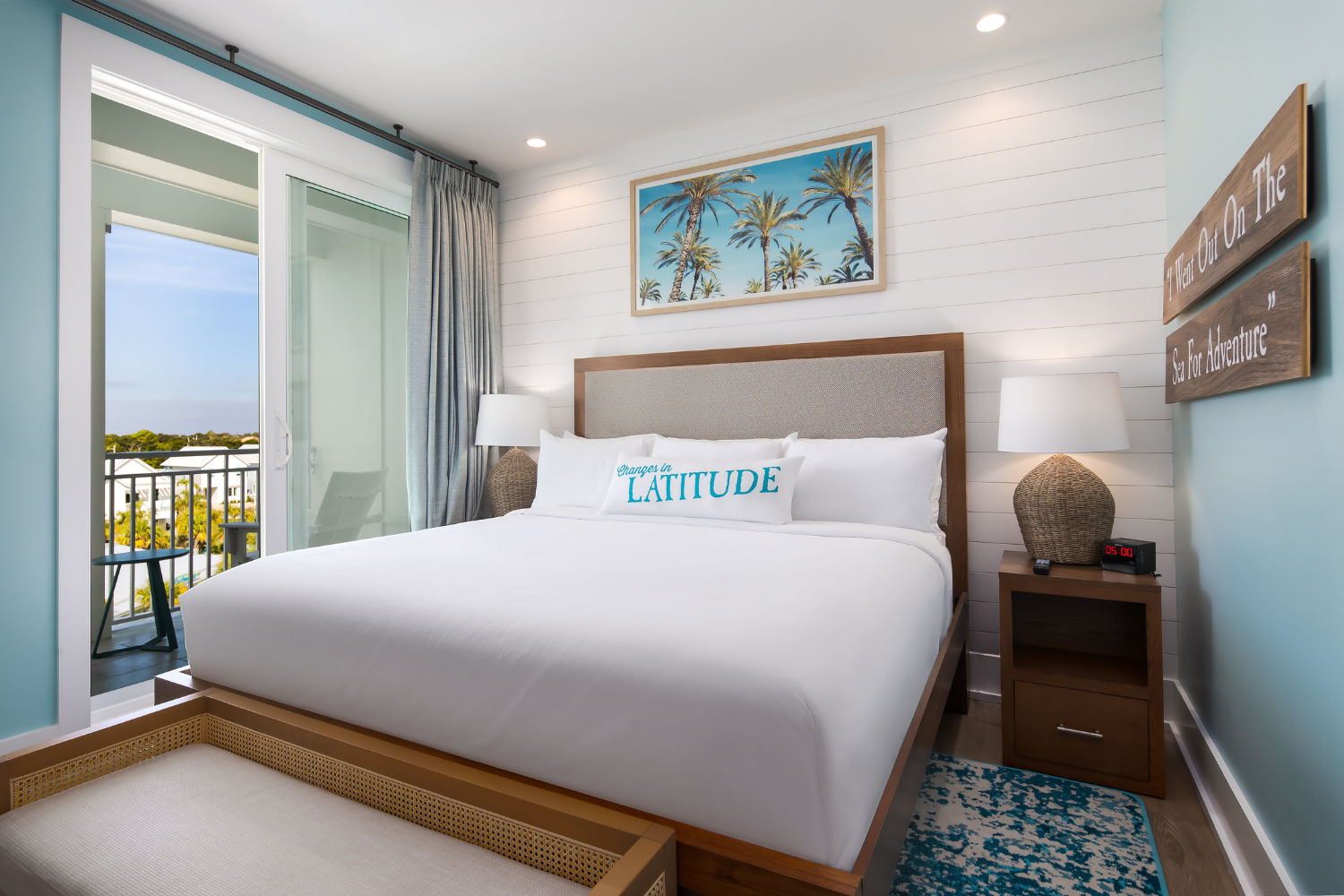 image This stylish bedroom blends comfort and charm with its tasteful decor and access to a private balcony.