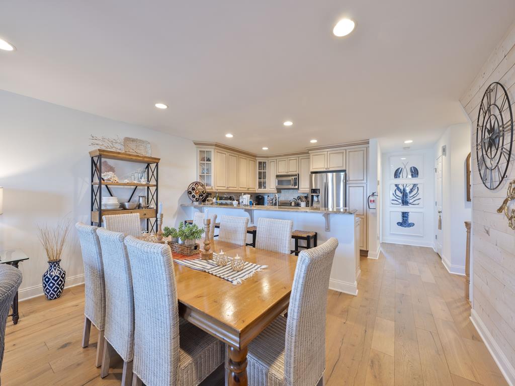 image Host meals at the rectangular dining table positioned between the kitchen and living area.