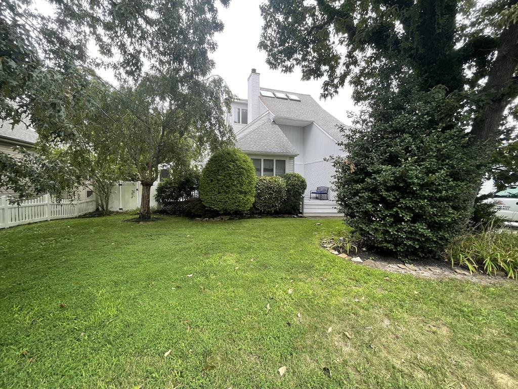 image Discover the tranquil backyard oasis at this family-friendly rental, surrounded by lush greenery and sunny spaces—ideal for relaxing afternoons.
