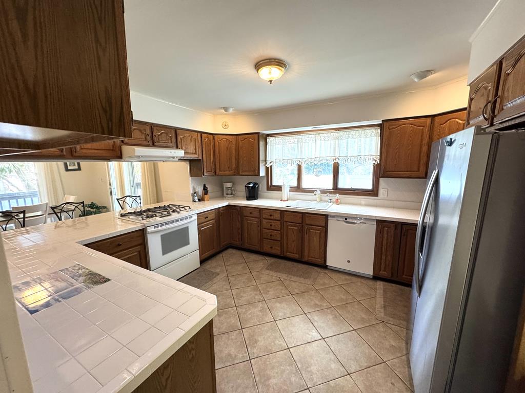 image This well-equipped kitchen features ample counter space, modern appliances, and inviting cabinetry, making cooking family meals a breeze while staying connected to the dining area.