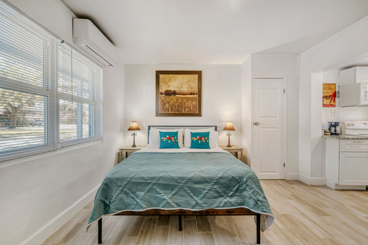 image Studio sleeping area with a queen bed, and natural light from nearby windows.