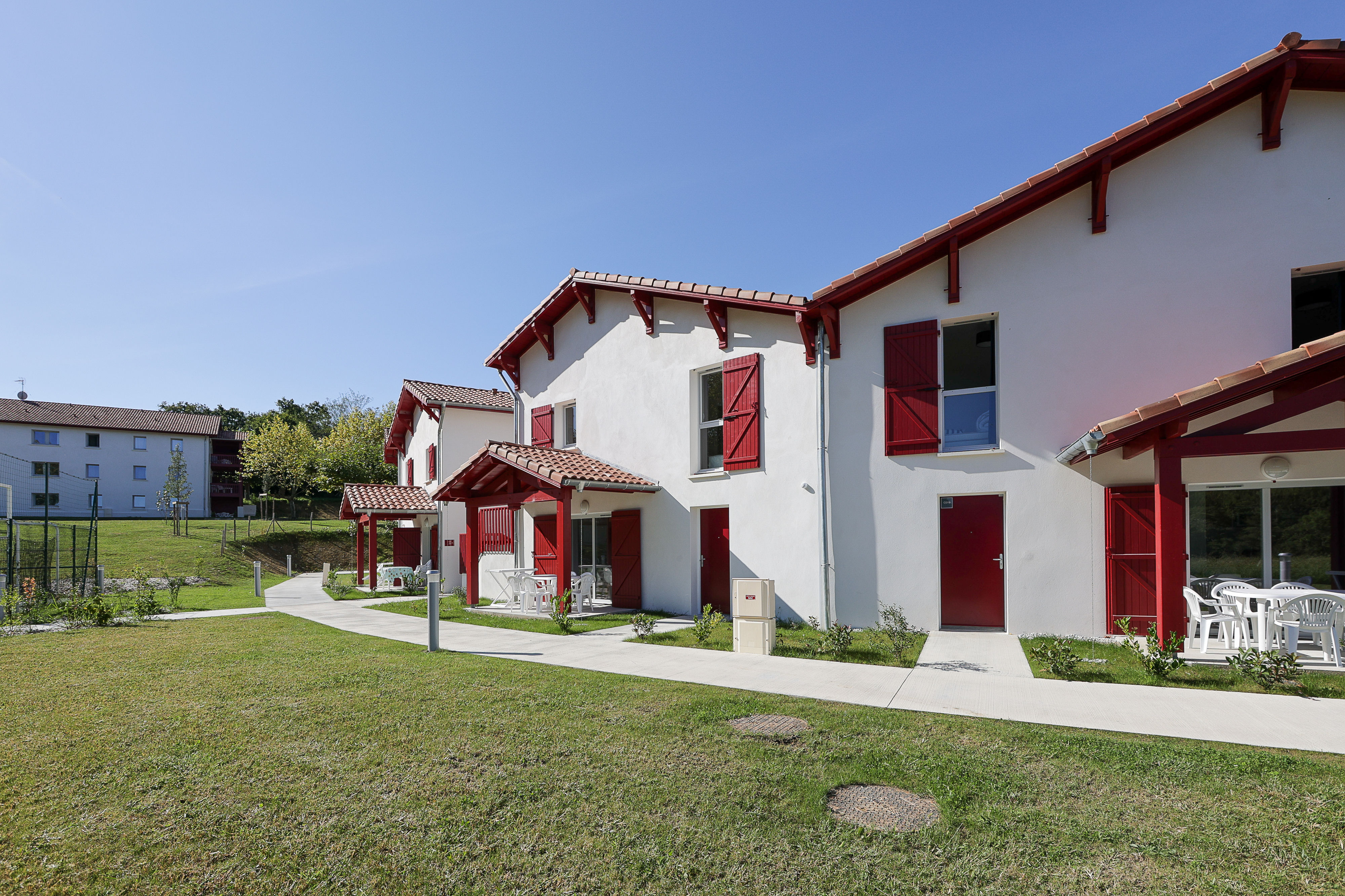 image Your two-bedroom apartment is nestled within the iconic red-and-white Basque architecture of Le Domaine d'Uhaina, steps away from the pools and resort facilities.