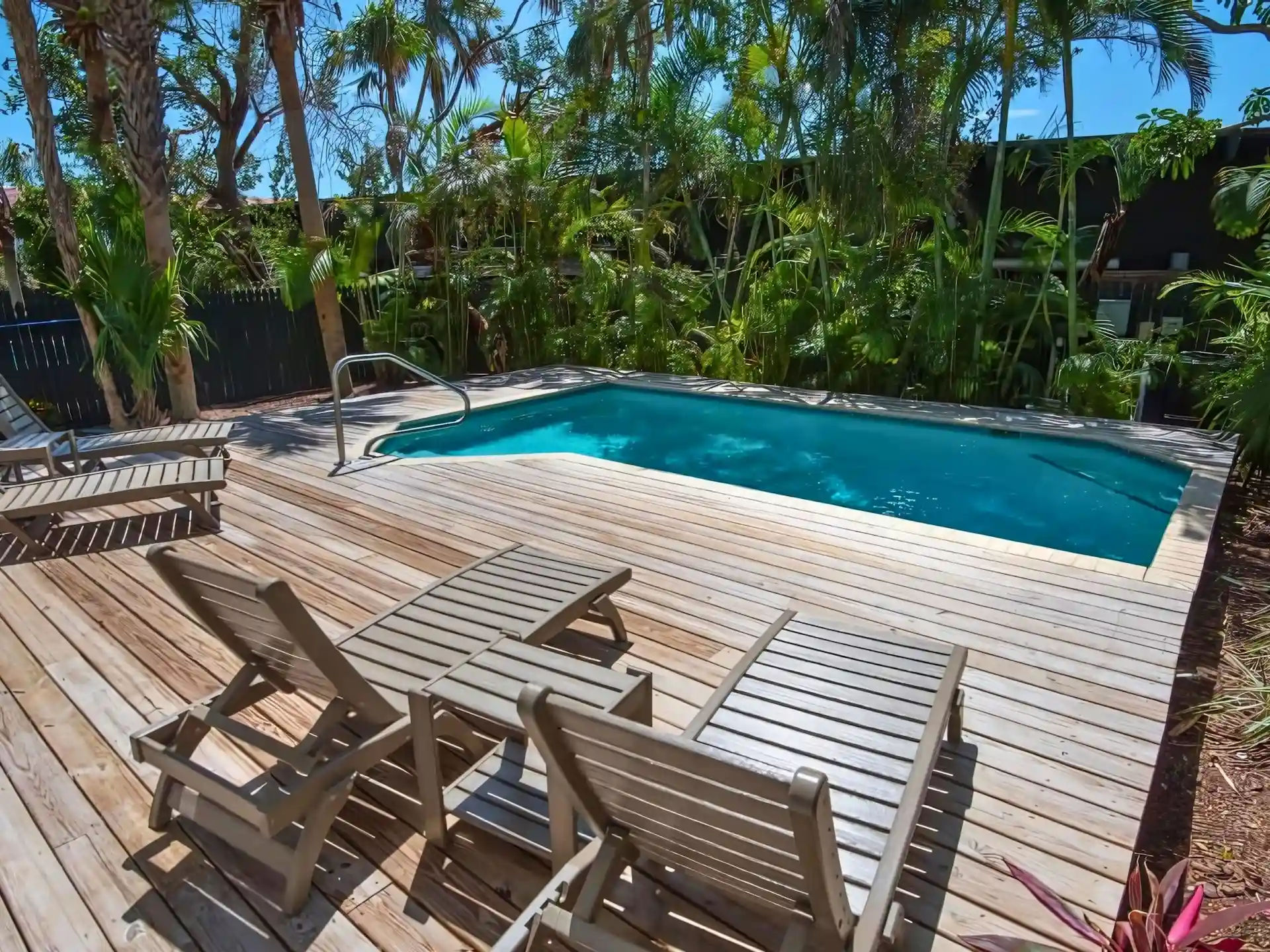 image Take a dip in your private pool surrounded by lush greenery; lounge chairs invite you to soak up the sun.