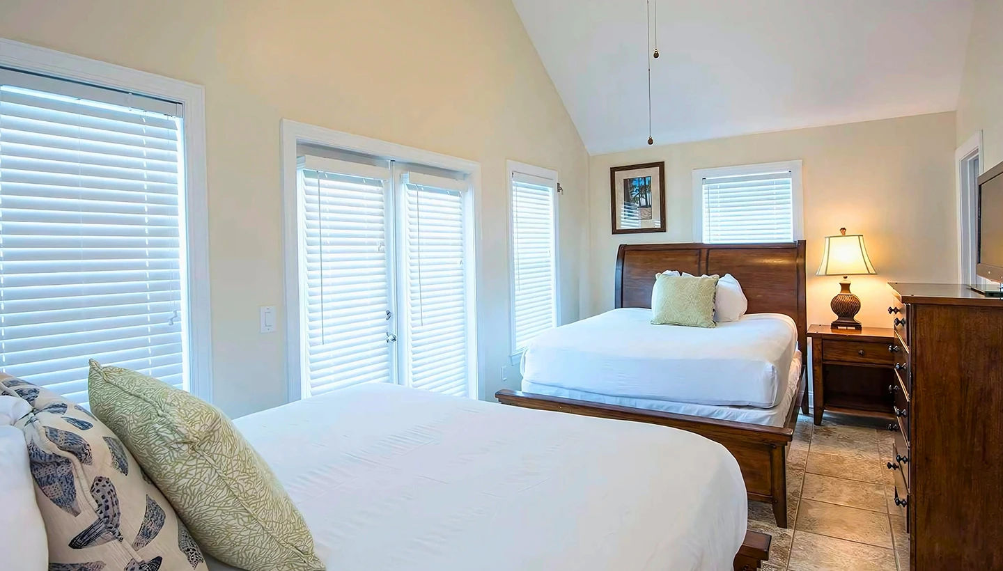 image Rest peacefully in this bright bedroom with multiple beds, ideal for family or friends.