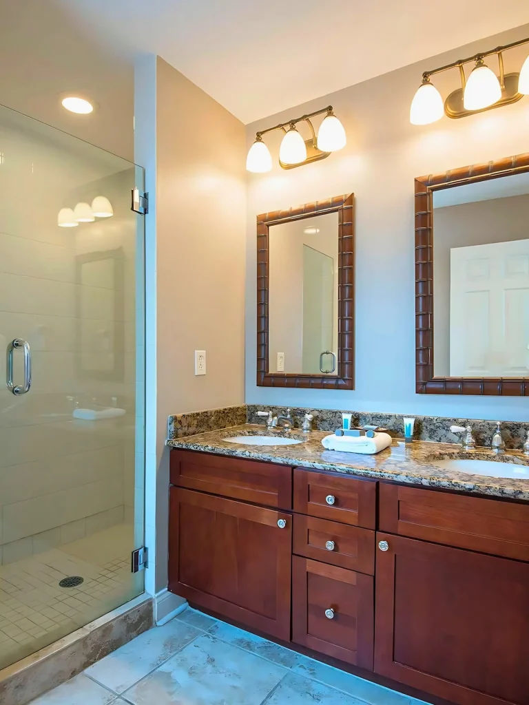 image Relax in this beautifully designed bathroom with double sinks and a walk-in shower, perfect for freshening up.