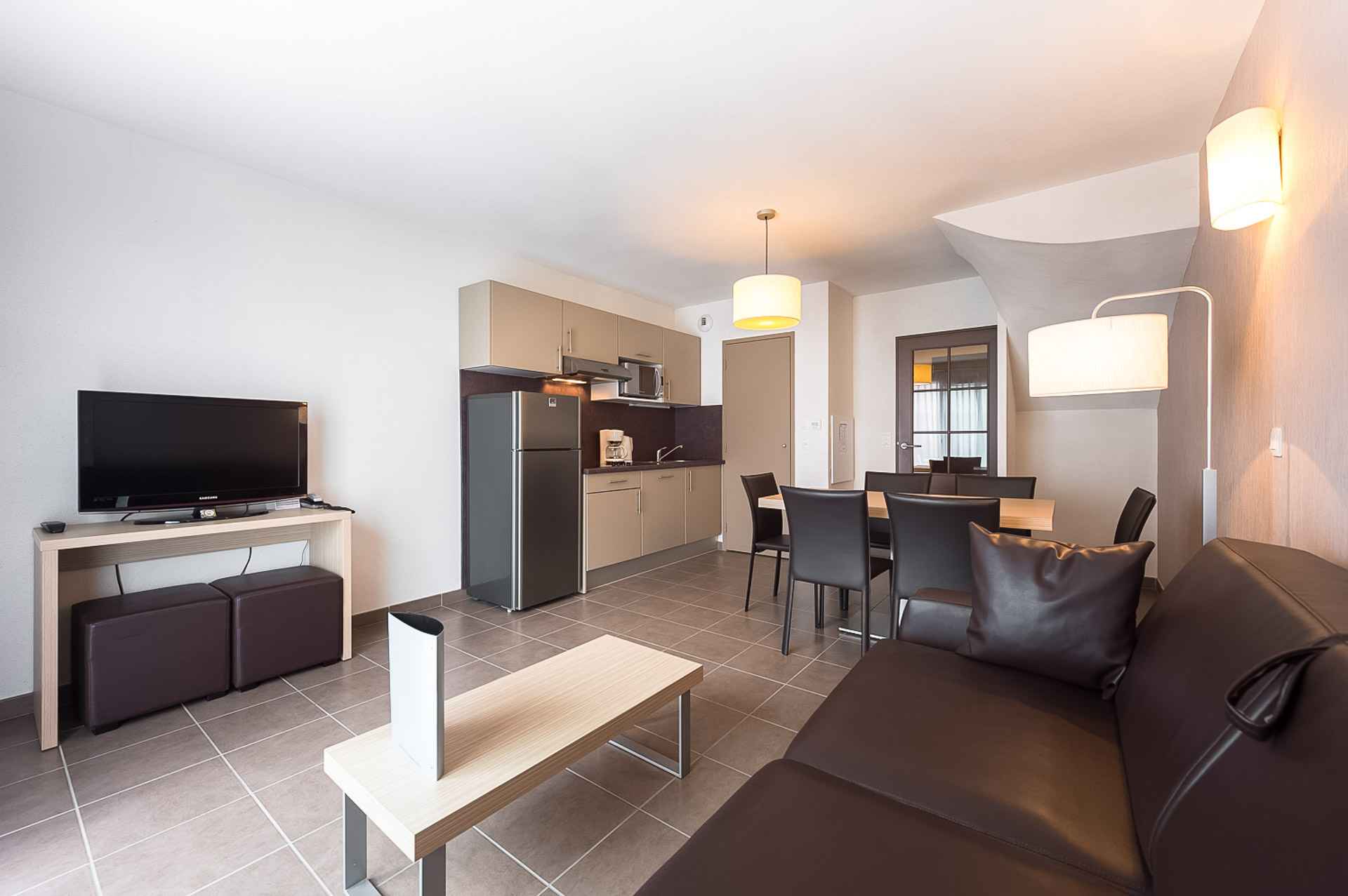 image A second kitchen angle showing storage, appliances, and the dining area — everything laid out for a comfortable stay.