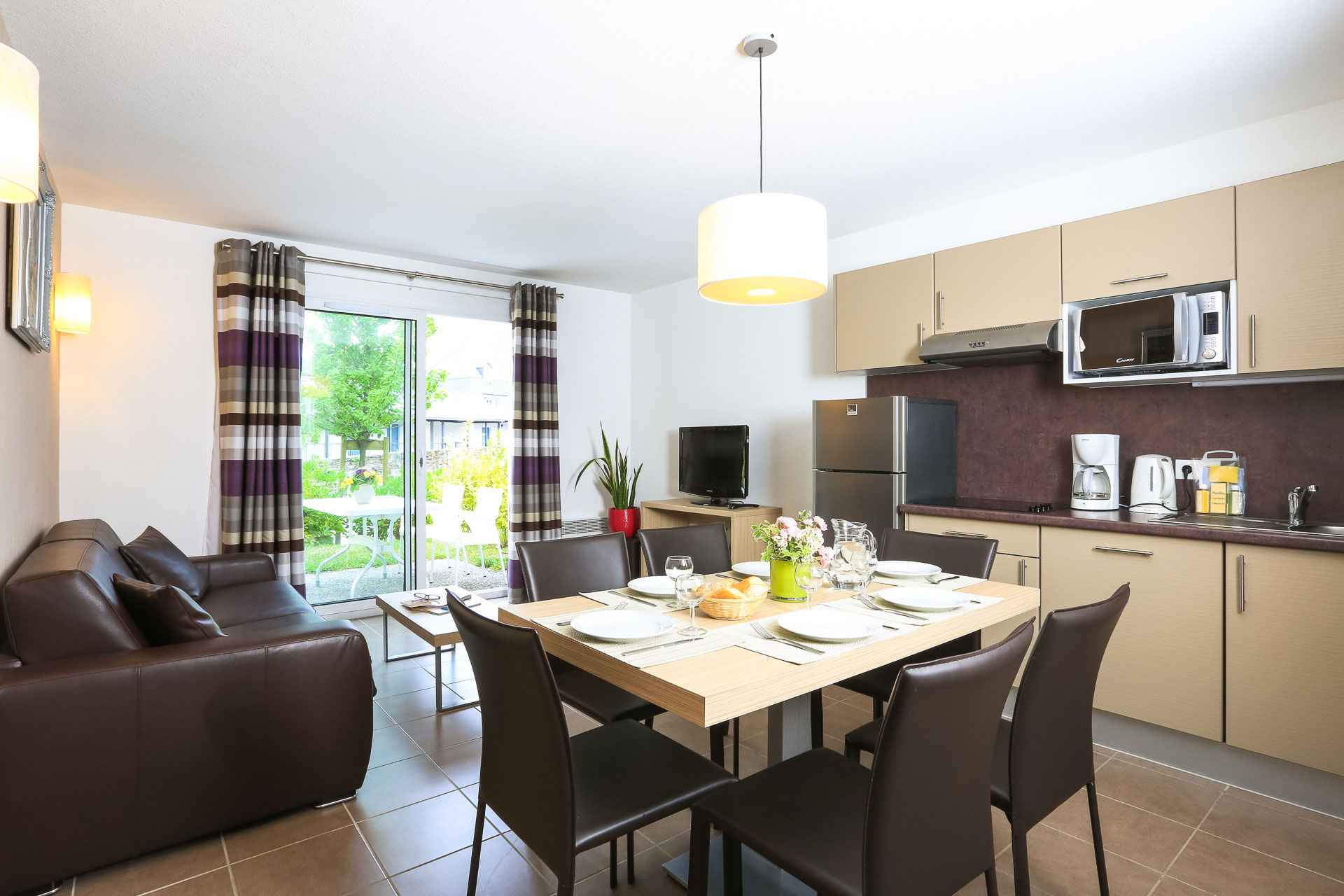image Open living and dining space with garden-facing windows — the private terrace is just beyond.