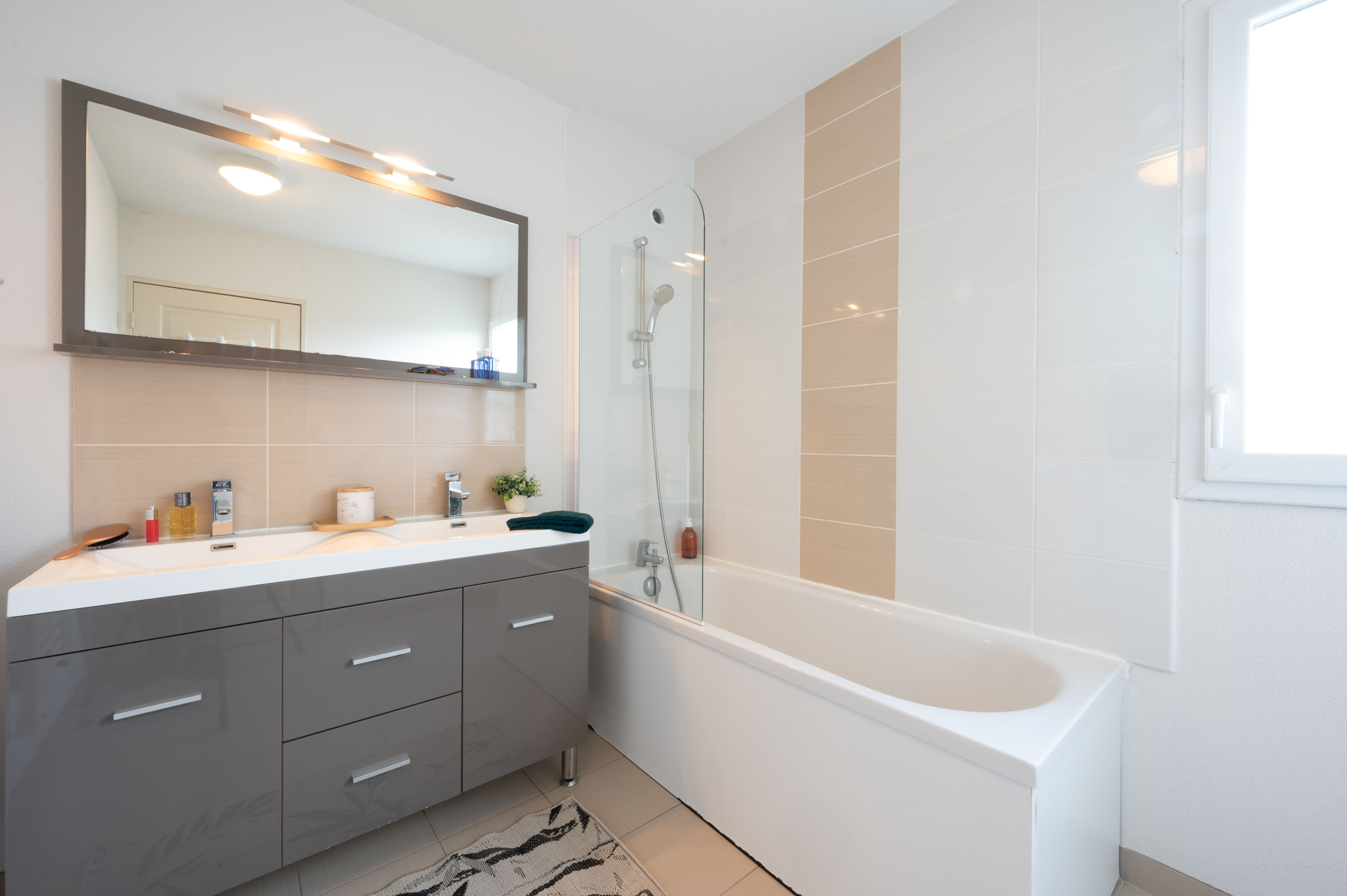 image The clean, modern bathroom with full bathtub has everything you need to unwind at the end of the day.