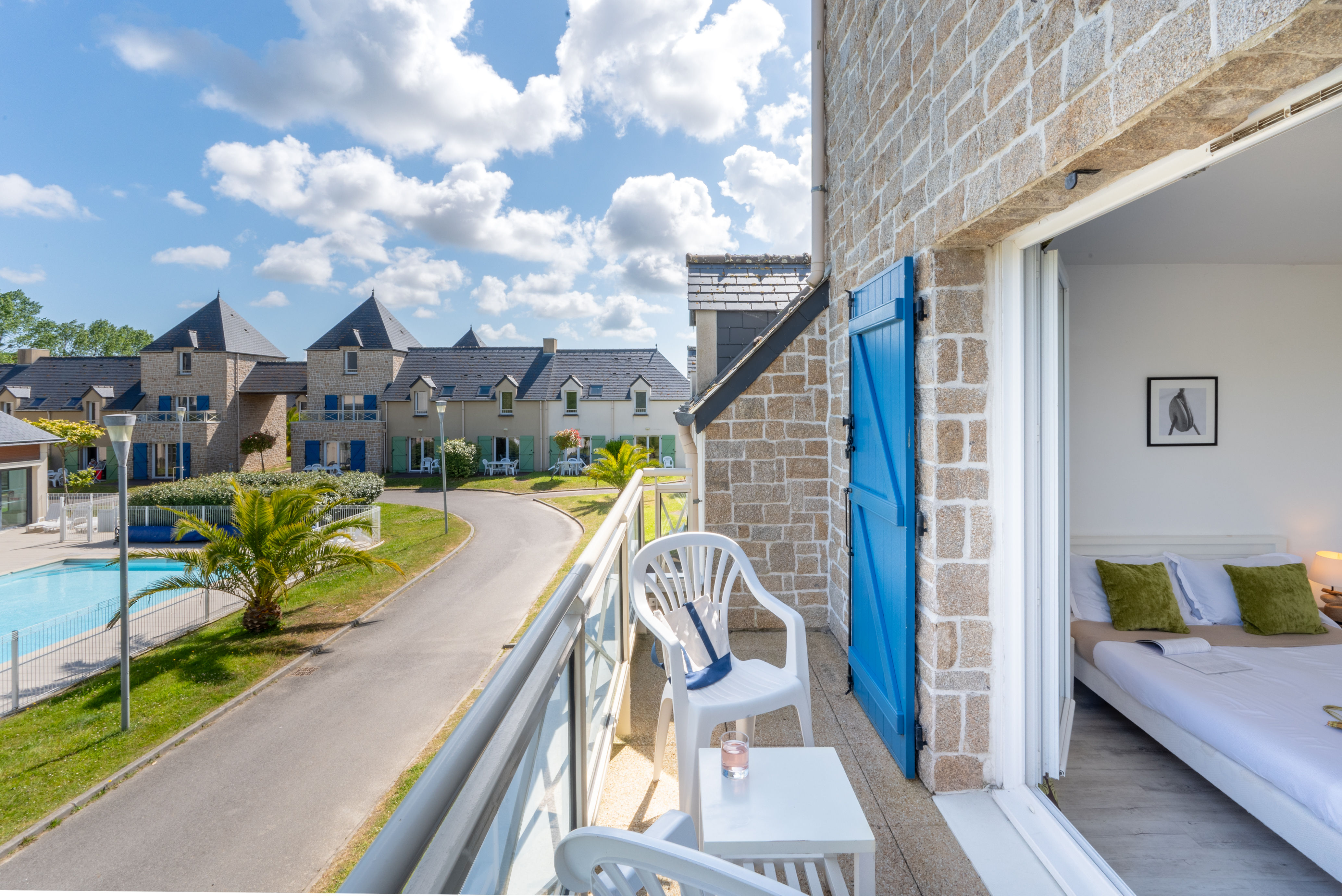 image Step out onto your private balcony and take in views over the domain's outdoor pool and the charming rooftops of the residence.