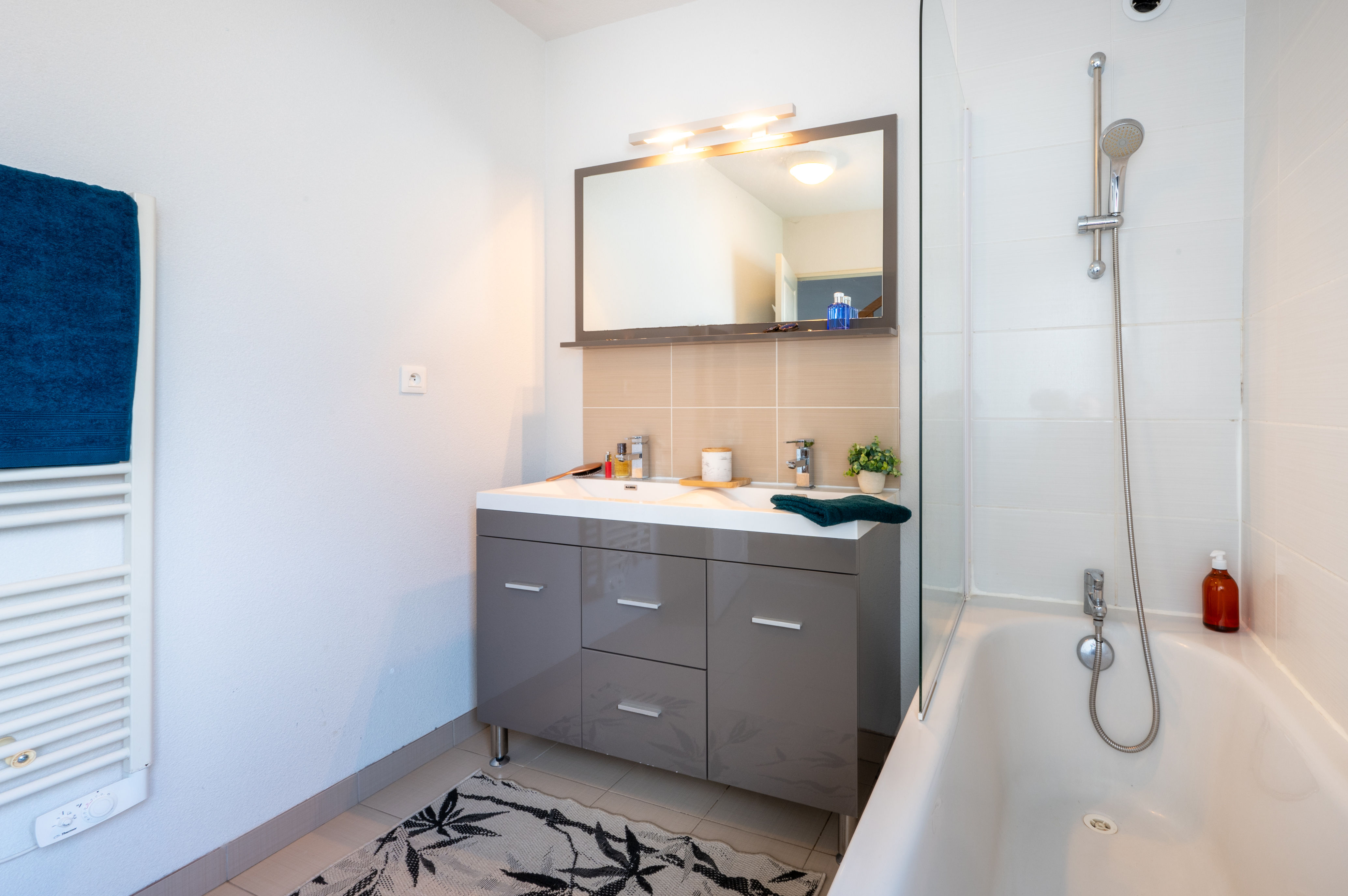 image The family bathroom comes equipped with both a bathtub and shower, making the morning routine easy for everyone.
