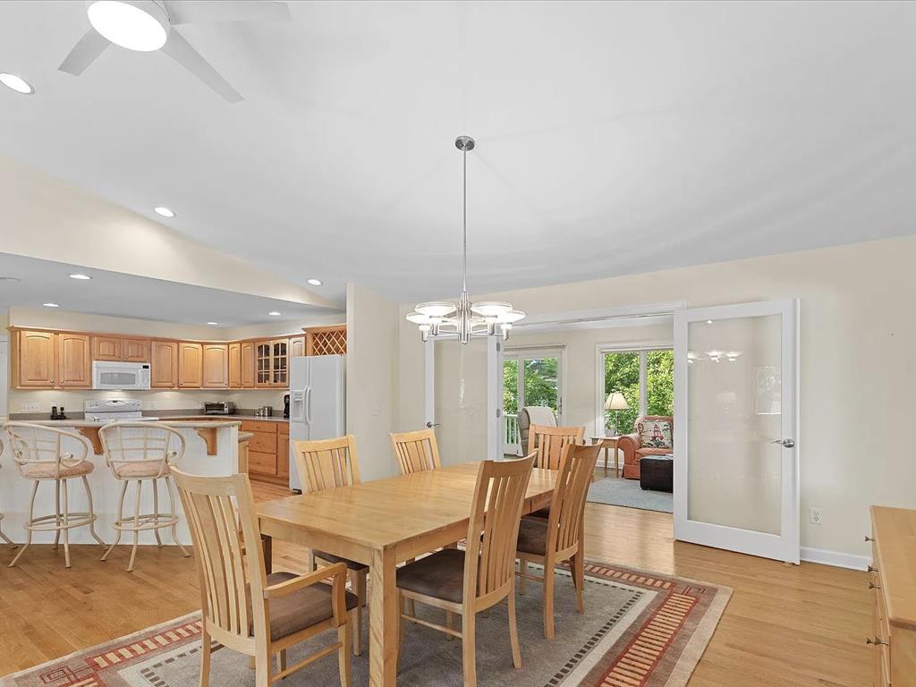 image Gather around the dining table, where warm wood tones invite lively meals and cherished memories.