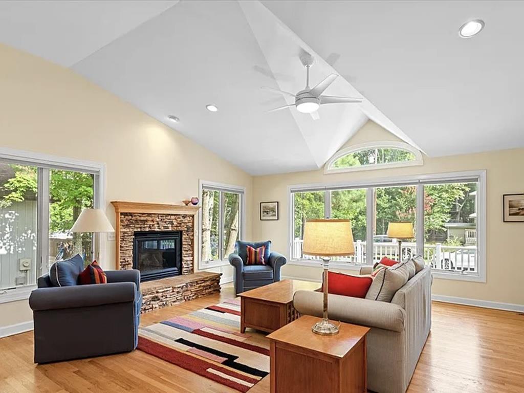 image Relax in the spacious great room, where natural light and cozy seating invite you to unwind.