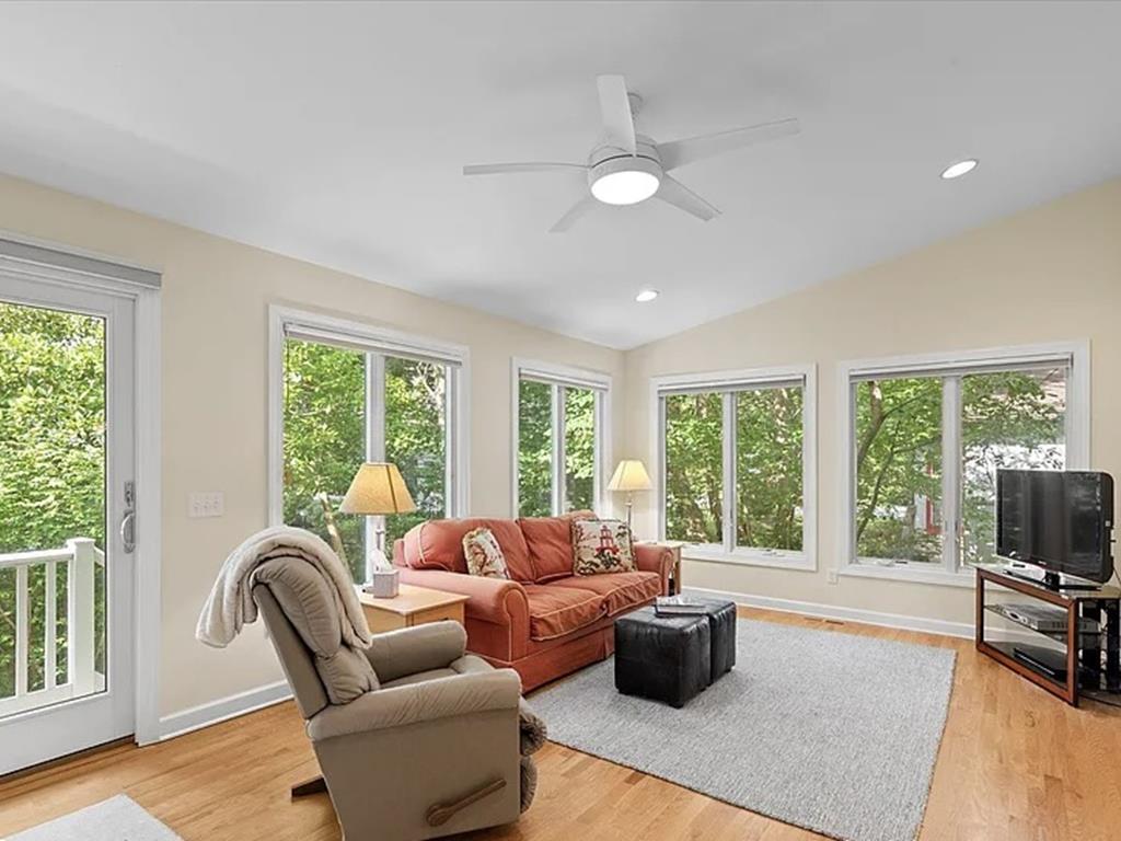 image Sink into comfort in the sunlit lounge, surrounded by windows that bring the outdoors in.